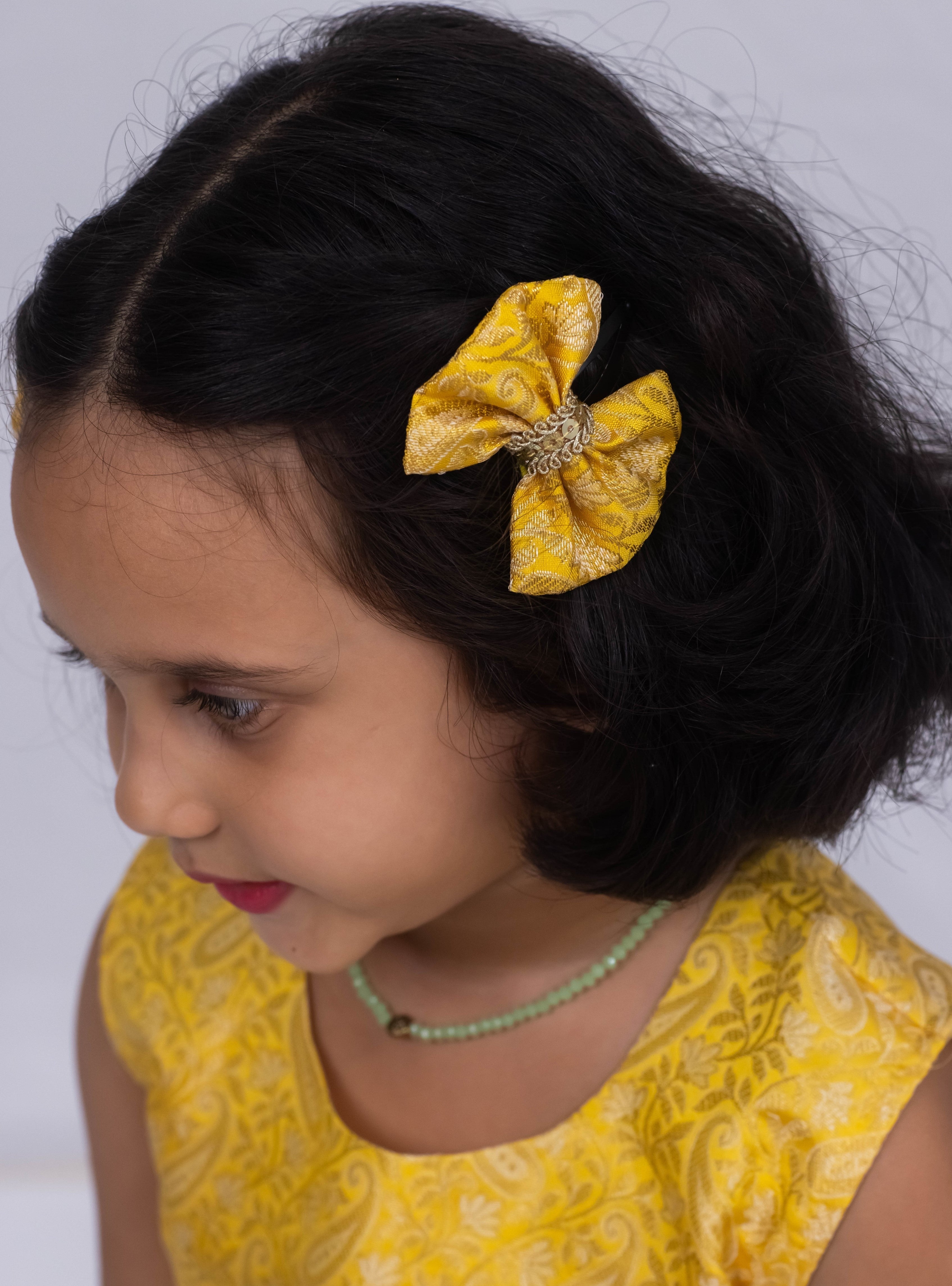 Introducing our latest product: a stunning yellow banarasi brocade yoke paired with a mint green raw silk pleated dress, complete with a delicate sequined lace waist detailing, designed specifically for girls. With its intricate craftsmanship and elegant color combination, this dress is sure to make a statement. Don't miss out on this unique addition to our collection!