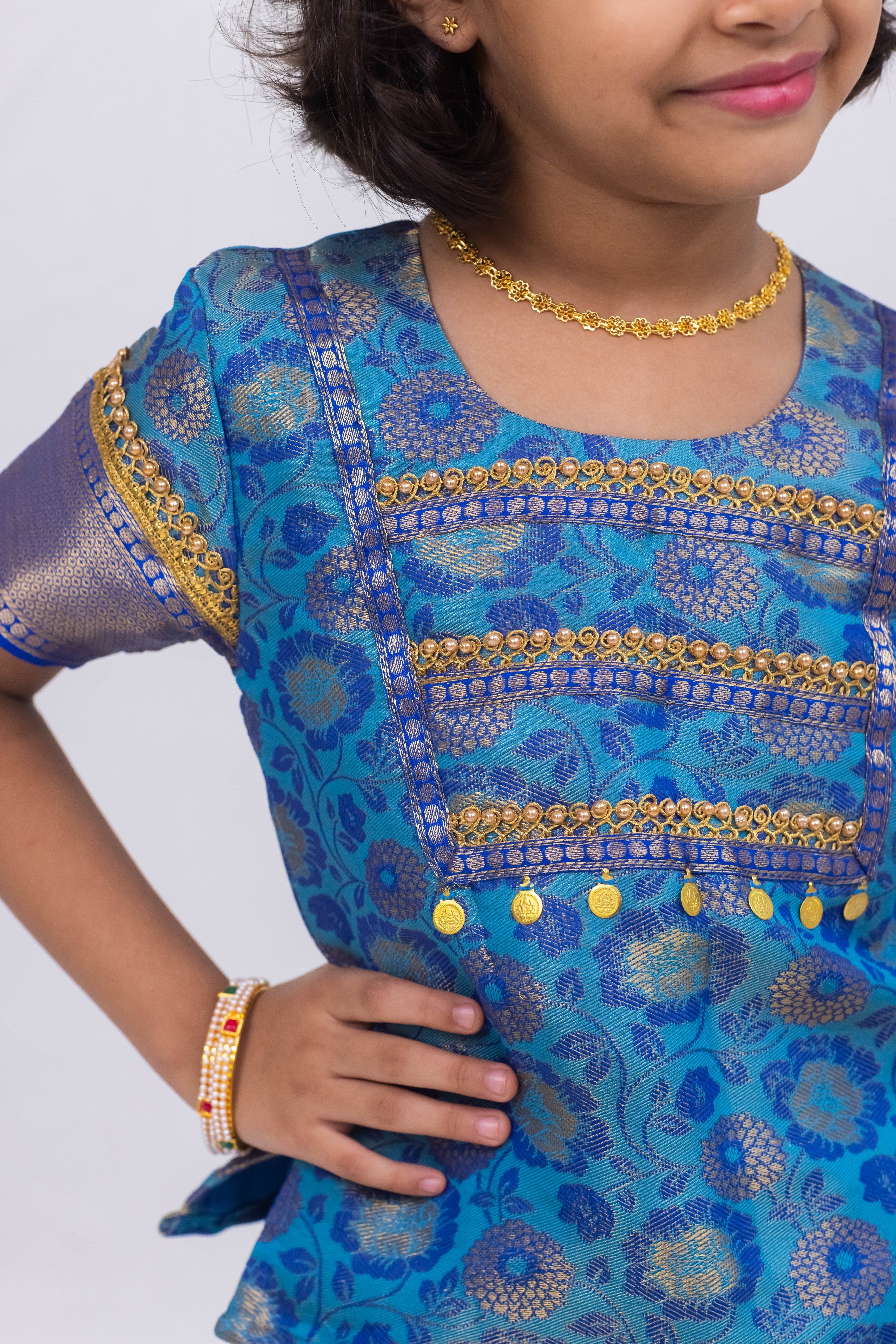 Blue banarasi jacquard brocade Pattu Pavada Parkar Polka set with a heavy yoke pattern for Girls.Let your princess be as comfortable as in her casuals with carefully designed & crafted Comfort Ethnic Wear by Soyara Ethnics.Keep her fashion quotient high with timeless patterns, vibrant combinations and royal textiles.