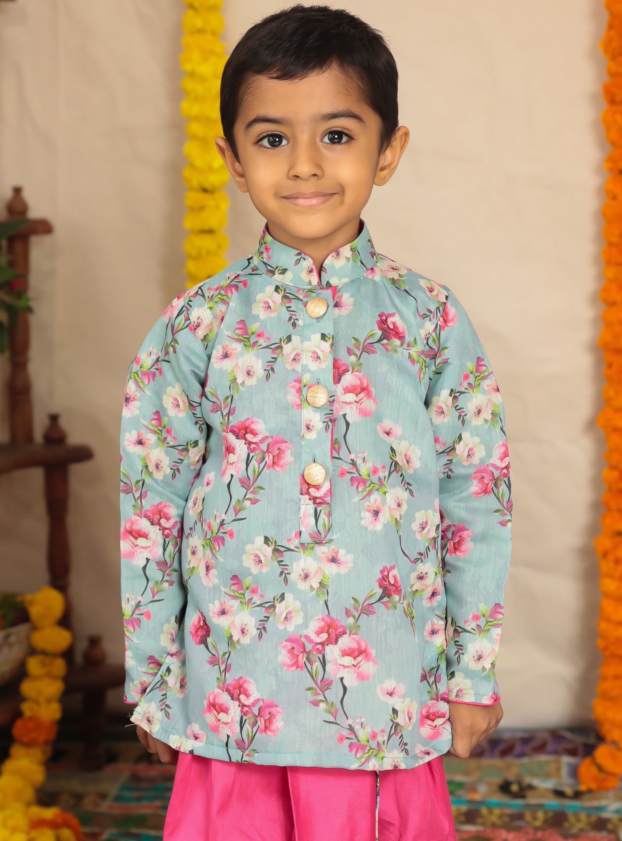 Grey floral printed kurta with pink cotton silk dhoti.Kurtas with collar or Angrakha pattern teamed with salwar are the best choice for any festive occasion for boys. They are Trendy, Easy to wear and comfortable to carry.