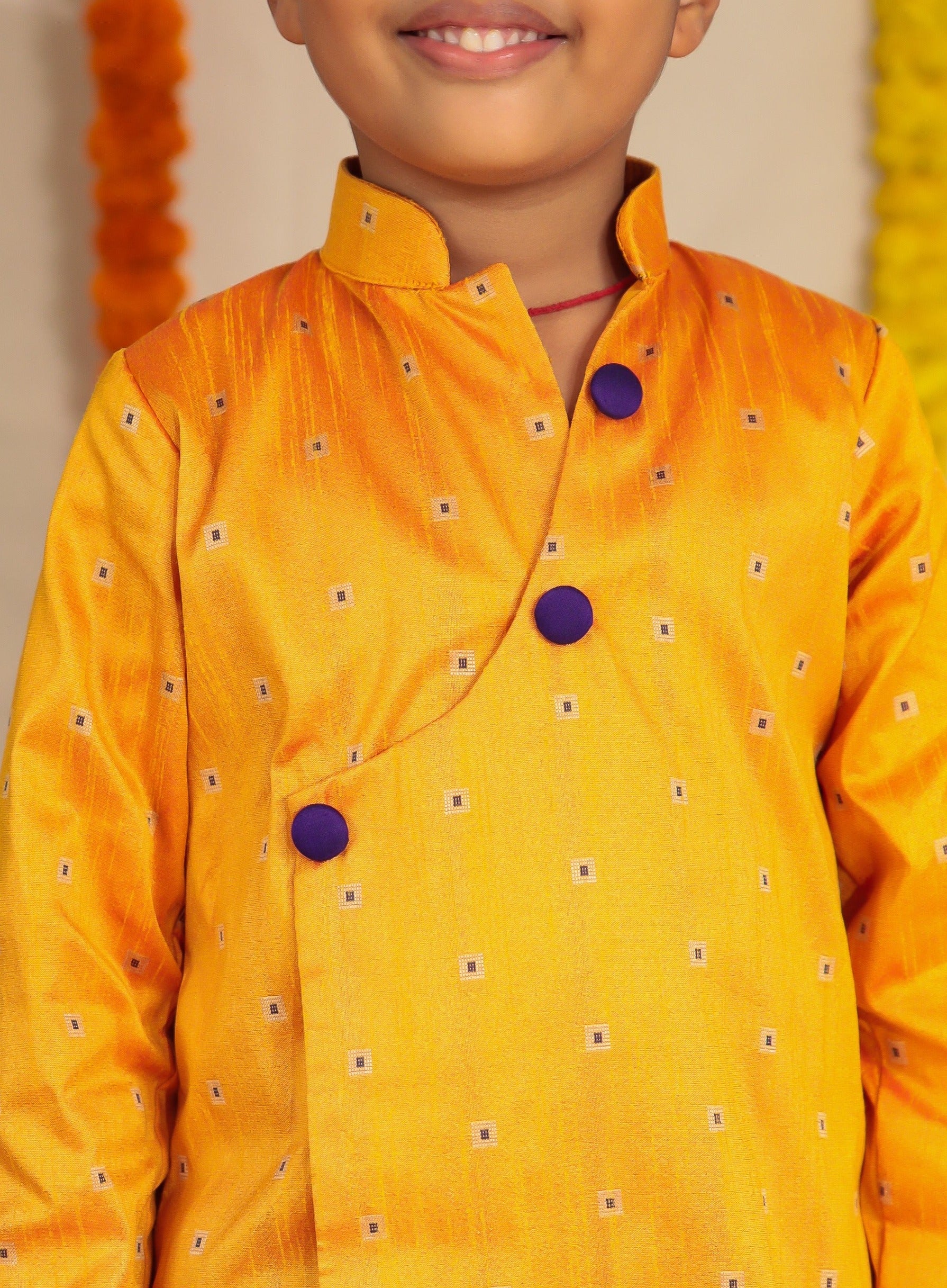 Mango coloured raw silk kurta and Purple cotton silk salwar set.Kurtas with collar or Angrakha pattern teamed with salwar are the best choice for any festive occasion for boys. They are Trendy, Easy to wear and comfortable to carry.