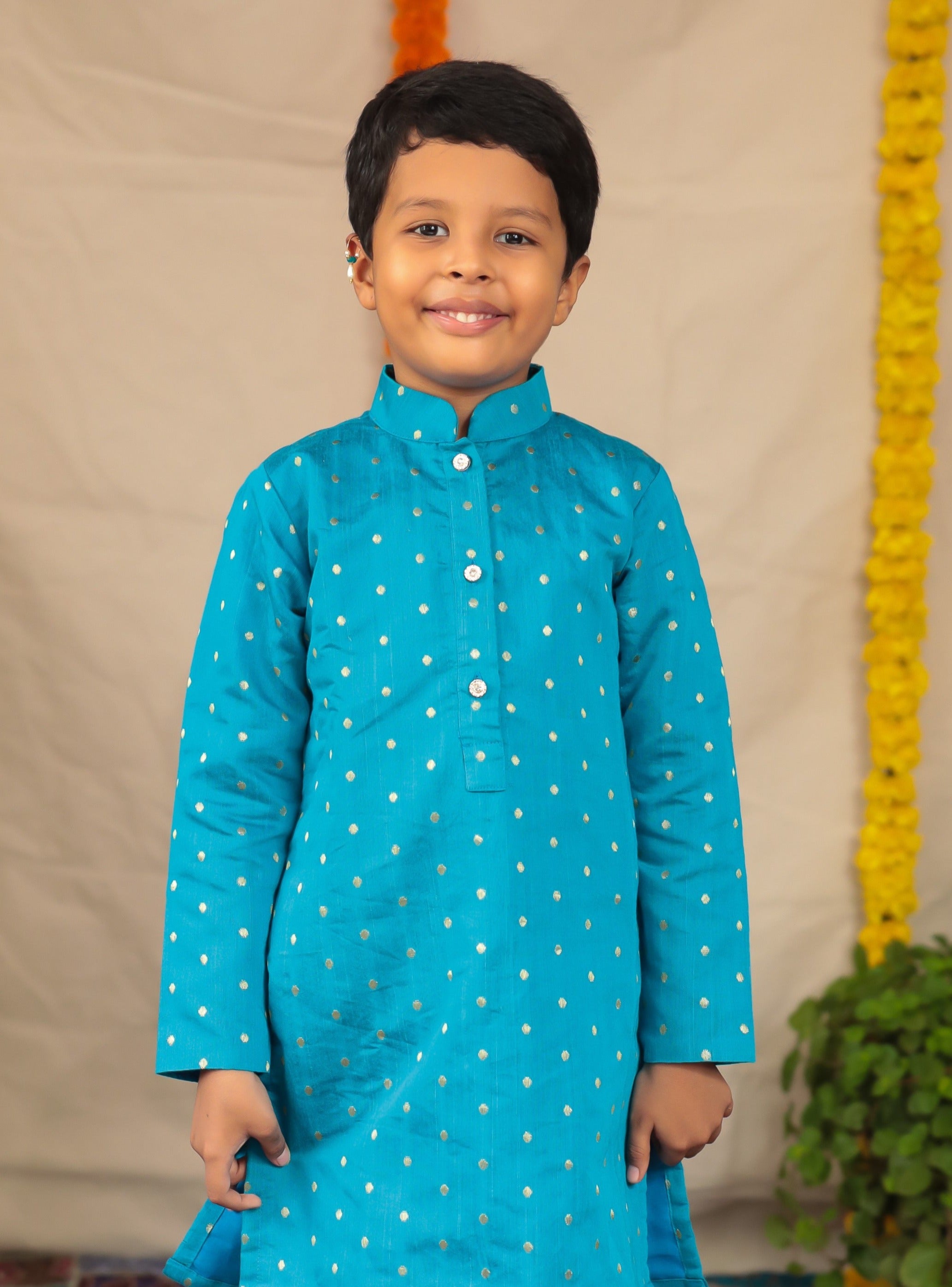 Teal blue Pine silk stand collar kurta with white cotton silk salwar set.Kurtas with collar or Angrakha pattern teamed with salwar are the best choice for any festive occasion for boys. They are Trendy, Easy to wear and comfortable to carry.