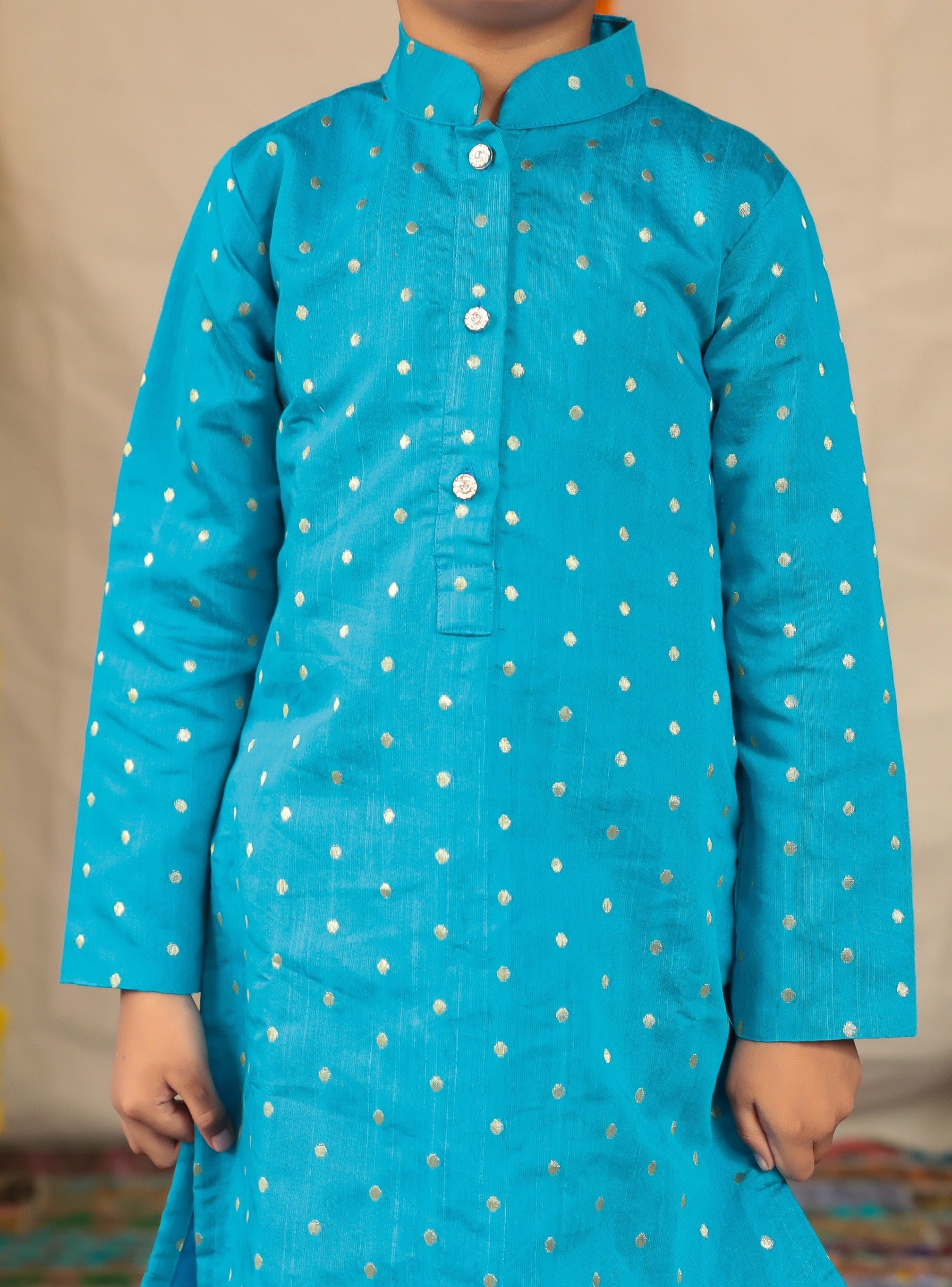 Teal blue Pine silk stand collar kurta with white cotton silk salwar set.Kurtas with collar or Angrakha pattern teamed with salwar are the best choice for any festive occasion for boys. They are Trendy, Easy to wear and comfortable to carry.
