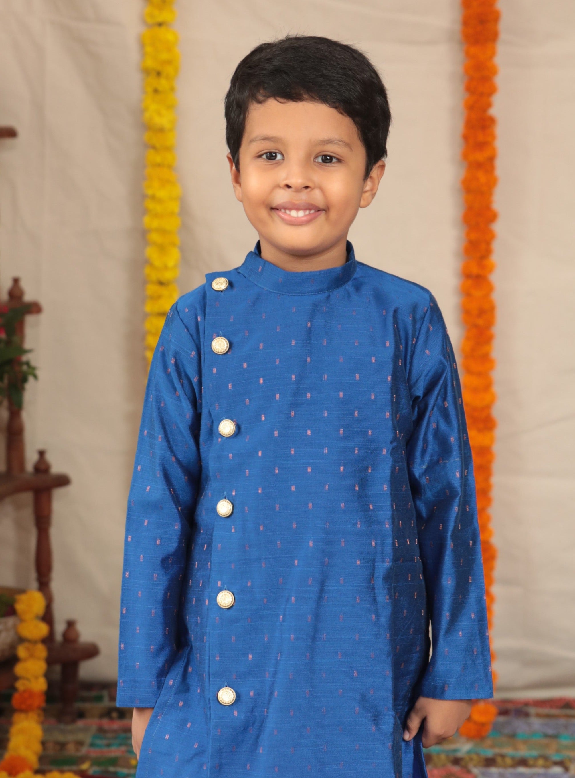 Royal blue pine silk Bandh Gala kurta with side placket and carrot pink cotton silk salwar set.Kurtas with collar or Angrakha pattern teamed with salwar are the best choice for any festive occasion for boys. They are Trendy, Easy to wear and comfortable to carry.