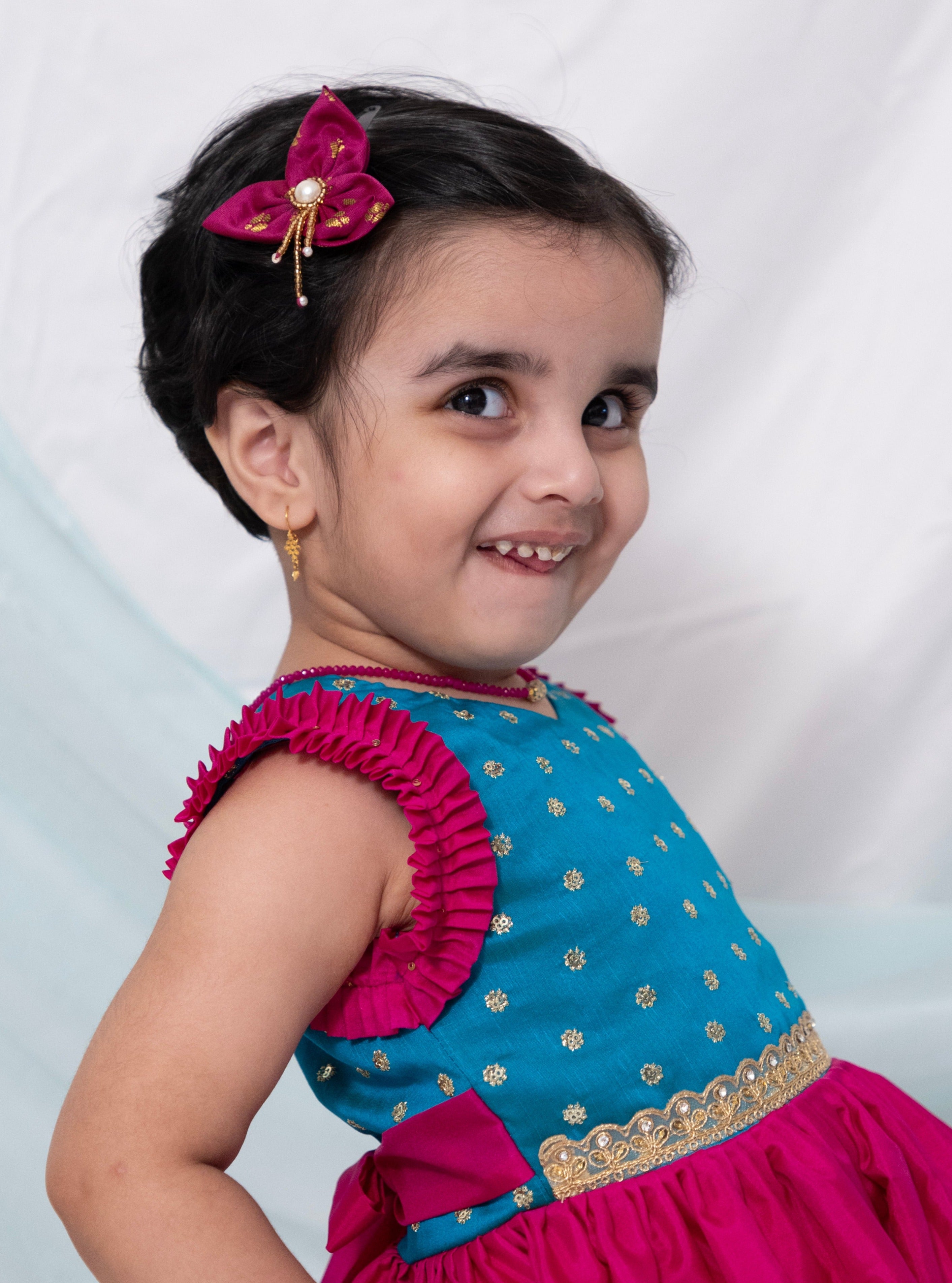 Teal blue sequined bodice with delicate lace embellishment and dark pink silk frock for Girl.Let your princess be as comfortable as in her casuals with carefully designed and crafted Comfort Ethnic Wear by Soyara Ethnics.Keep her fashion quotient high with timeless patterns, vibrant combinations and royal textiles.