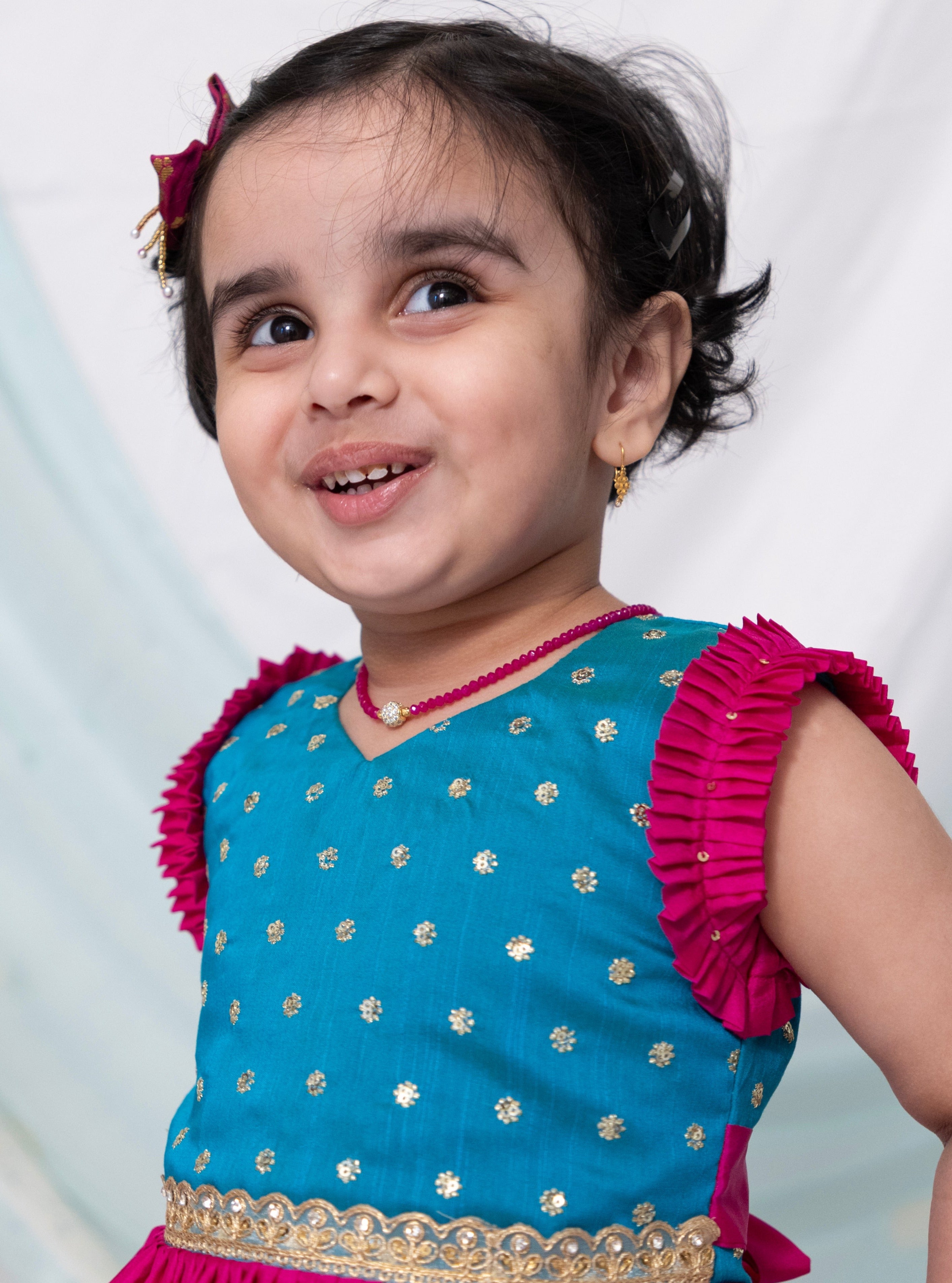 Teal blue sequined bodice with delicate lace embellishment and dark pink silk frock for Girl.Let your princess be as comfortable as in her casuals with carefully designed and crafted Comfort Ethnic Wear by Soyara Ethnics.Keep her fashion quotient high with timeless patterns, vibrant combinations and royal textiles.