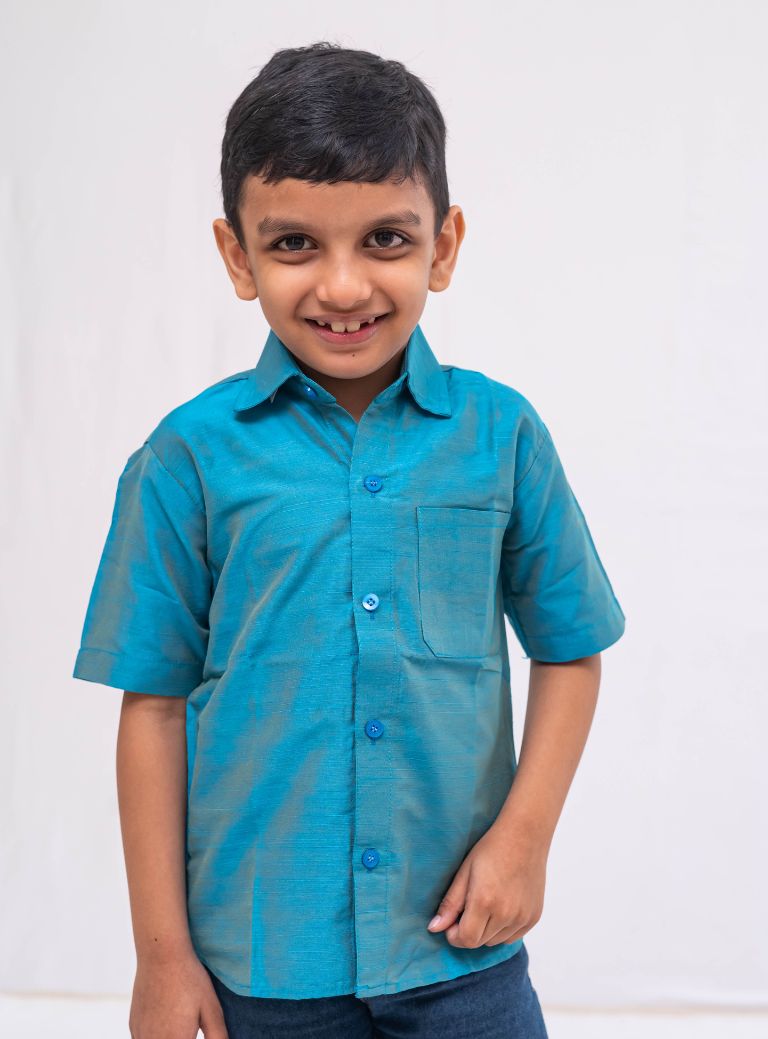 Teal Blue Plain Raw silk half sleeved shirt for Boys.This Teal Blue Plain Raw silk half sleeved shirt is designed for boys, providing both comfort and style.