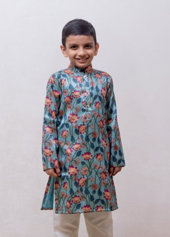 This Greish Sky blue tussar silk kurta features a lotus print and a stand collar accented with stone buttons. It is lined with cotton on the inside to provide enhanced comfort and superior quality.