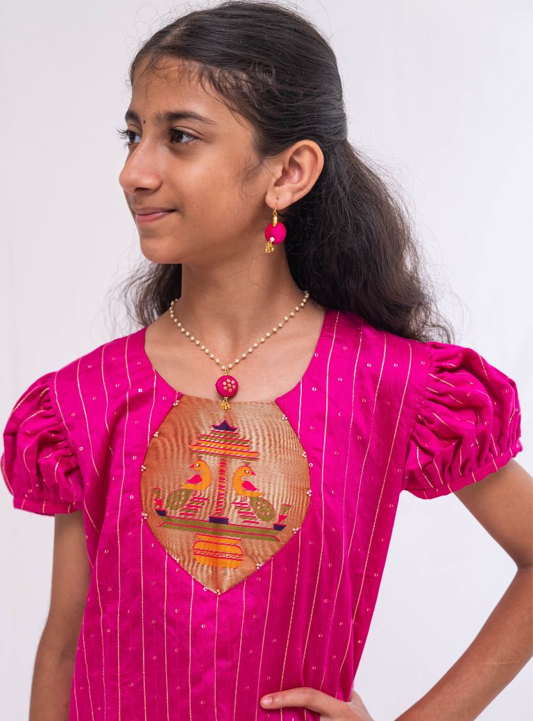 Dark Pink satin chanderi sequined, puff sleeved kurti with paithani yoke pattern for Girls.Let your princess be as comfortable as in her casuals with carefully designed & crafted Comfort Ethnic Wear by Soyara Ethnics.Keep her fashion quotient high with timeless patterns, vibrant combinations and royal textiles.