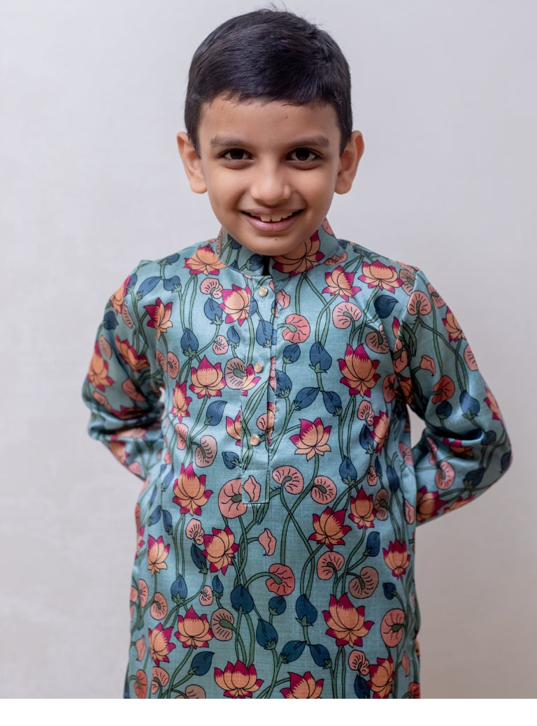 This Greish Sky blue tussar silk kurta features a lotus print and a stand collar accented with stone buttons. It is lined with cotton on the inside to provide enhanced comfort and superior quality.