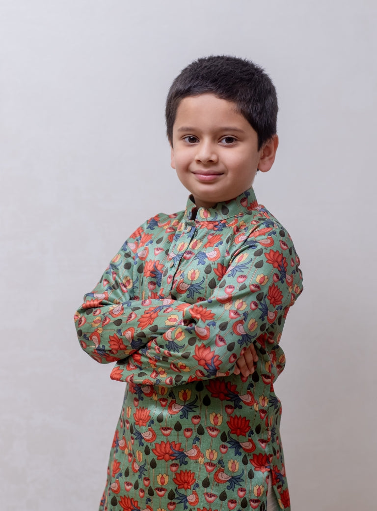 This Sage Green tussar silk kurta features a lotus print and a stand collar accented with stone buttons. It is lined with cotton on the inside to provide enhanced comfort and superior quality.