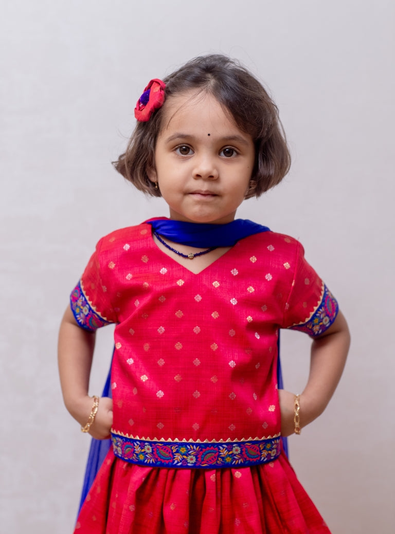 Tomato red Raw silk Ghagra choli with shocking blue fulkari embroidered border at the bottom and sleeves for Girls.Let your princess be as comfortable as in her casuals with carefully designed and crafted Comfort Ethnic Wear by Soyara Ethnics. Keep her fashion quotient high with timeless patterns, vibrant combinations and royal textiles.