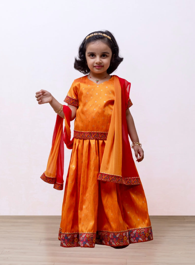 Turmeric Yellow Raw silk Ghagra choli with burning red fulkari embroidered border at the bottom and sleeves for Girls.Let your princess be as comfortable as in her casuals with carefully designed and crafted Comfort Ethnic Wear by Soyara Ethnics. Keep her fashion quotient high with timeless patterns, vibrant combinations and royal textiles.