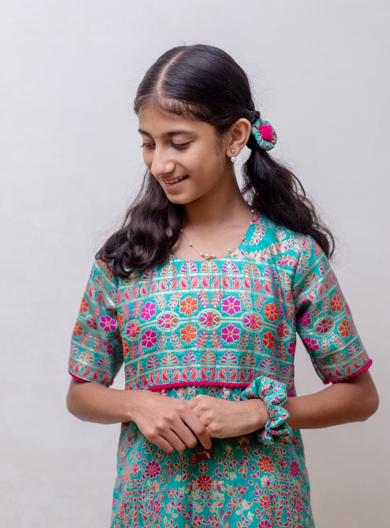 Turquoise soft silk Banaras brocade kurti with yoke pattern embellished with contrast pompom lace for Girls
