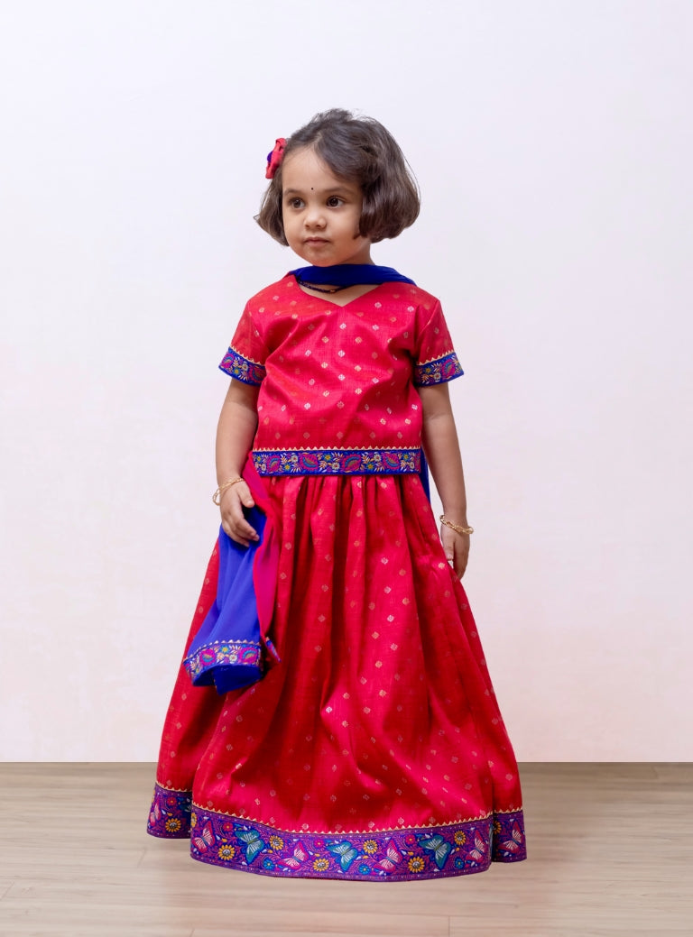 Tomato red Raw silk Ghagra choli with shocking blue fulkari embroidered border at the bottom and sleeves for Girls.Let your princess be as comfortable as in her casuals with carefully designed and crafted Comfort Ethnic Wear by Soyara Ethnics. Keep her fashion quotient high with timeless patterns, vibrant combinations and royal textiles.