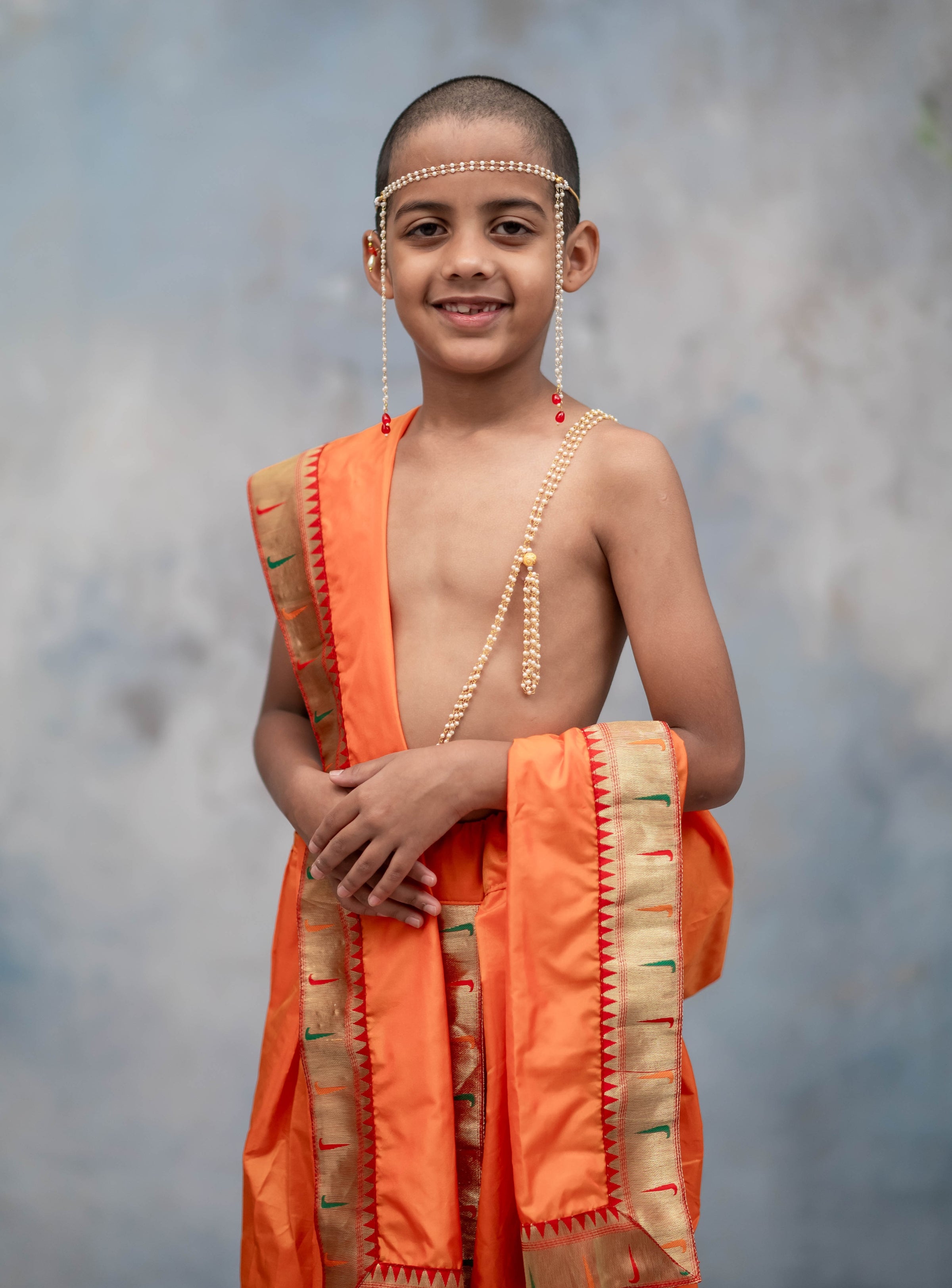 Saffron Mysore silk sovale uparane set with Muniya Paithani border for Batu.Pre-stitched sovale uparane set includes Ready to wear Sovale & Uparane/Upavastra.Can be paired with a short kurta.This Set is ideal for rituals like Matrubhojan,Muhurt during Munj/Upanayan/Vratabandha/Thread Ceremony.