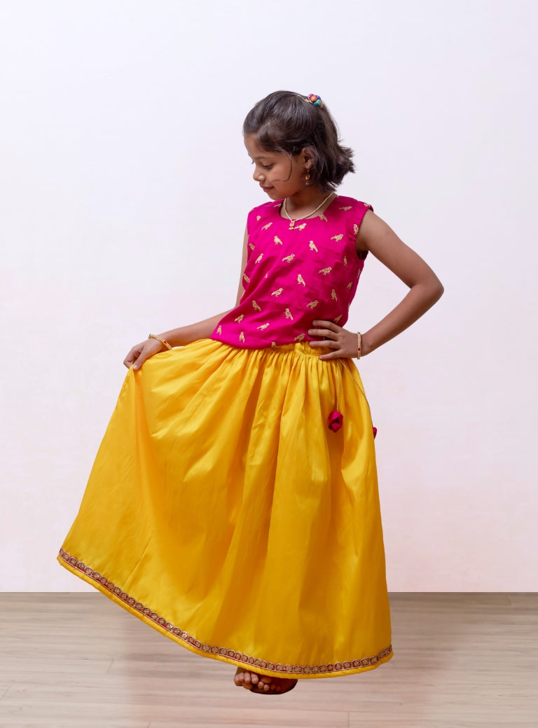 Fresh Yellow soft taffeta silk Ghagra with rani pink asymmetric embroidered gajji silk choli for Girls.Let your princess be as comfortable as in her casuals with carefully designed and crafted Comfort Ethnic Wear by Soyara Ethnics. Keep her fashion quotient high with timeless patterns, vibrant combinations and royal textiles.