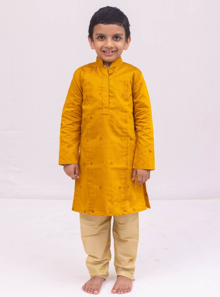 This Mustered Yellow kurta for boys features a knife pleated design crafted from raw silk. Adorned with jari buttas, it boasts a stand collar and front placket opening for a sophisticated touch. The cotton lining on the inside ensures comfort and quality.