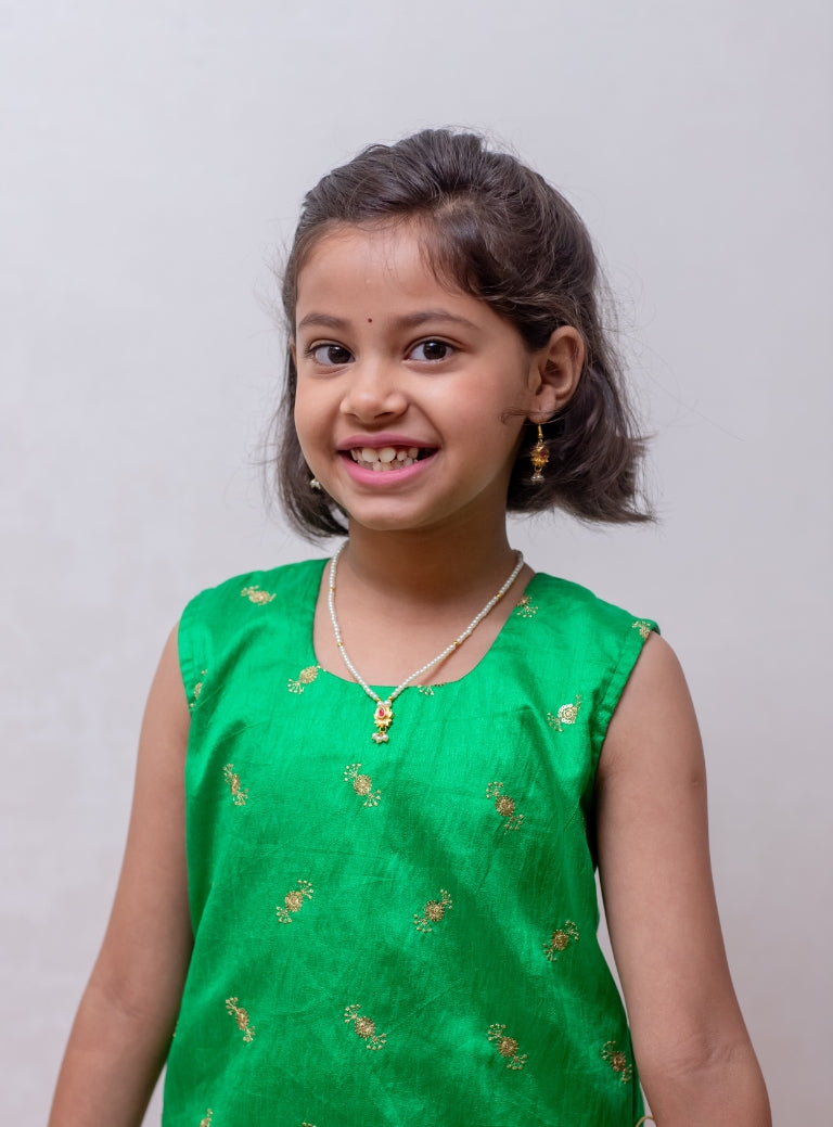 Rani pink soft taffeta silk Ghagra with shocking parrot green asymmetric embroidered gajji silk choli for Girls.Let your princess be as comfortable as in her casuals with carefully designed and crafted Comfort Ethnic Wear by Soyara Ethnics. Keep her fashion quotient high with timeless patterns, vibrant combinations and royal textiles.