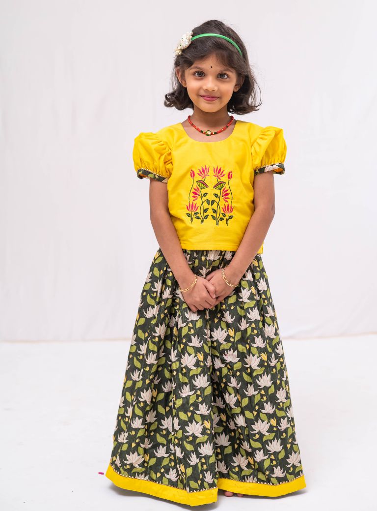 This Bottle green digital printed modal silk ghagra is a perfect choice for girls. It features sunshine yellow hand embroidered choli with gotta patti embellishments, adding a touch of elegance and style.