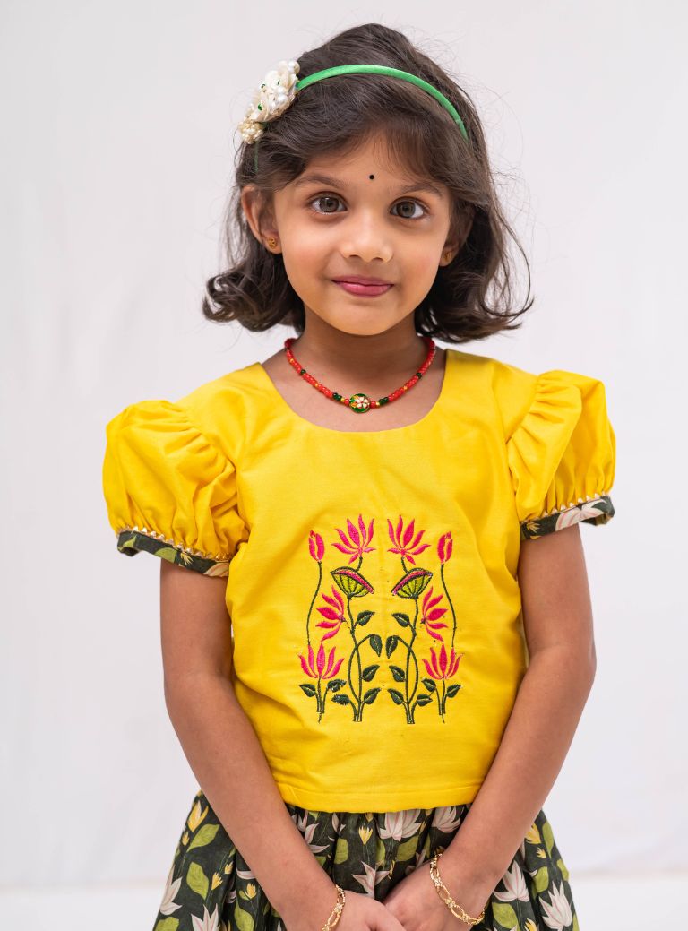 This Bottle green digital printed modal silk ghagra is a perfect choice for girls. It features sunshine yellow hand embroidered choli with gotta patti embellishments, adding a touch of elegance and style.