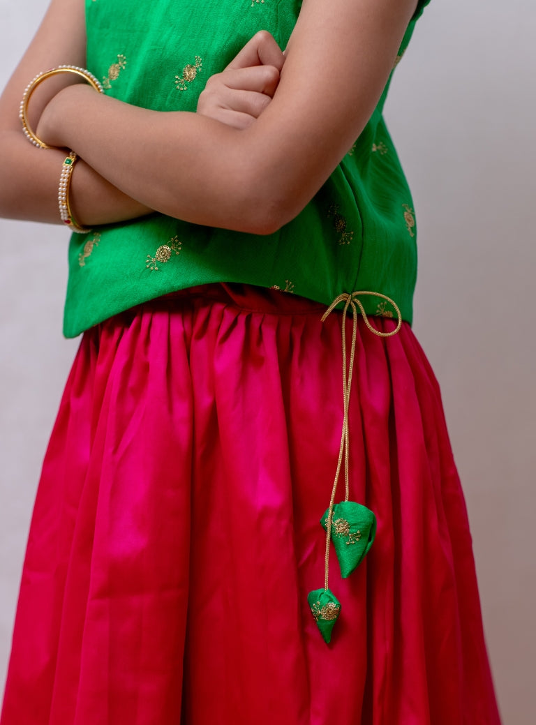 Rani pink soft taffeta silk Ghagra with shocking parrot green asymmetric embroidered gajji silk choli for Girls.Let your princess be as comfortable as in her casuals with carefully designed and crafted Comfort Ethnic Wear by Soyara Ethnics. Keep her fashion quotient high with timeless patterns, vibrant combinations and royal textiles.