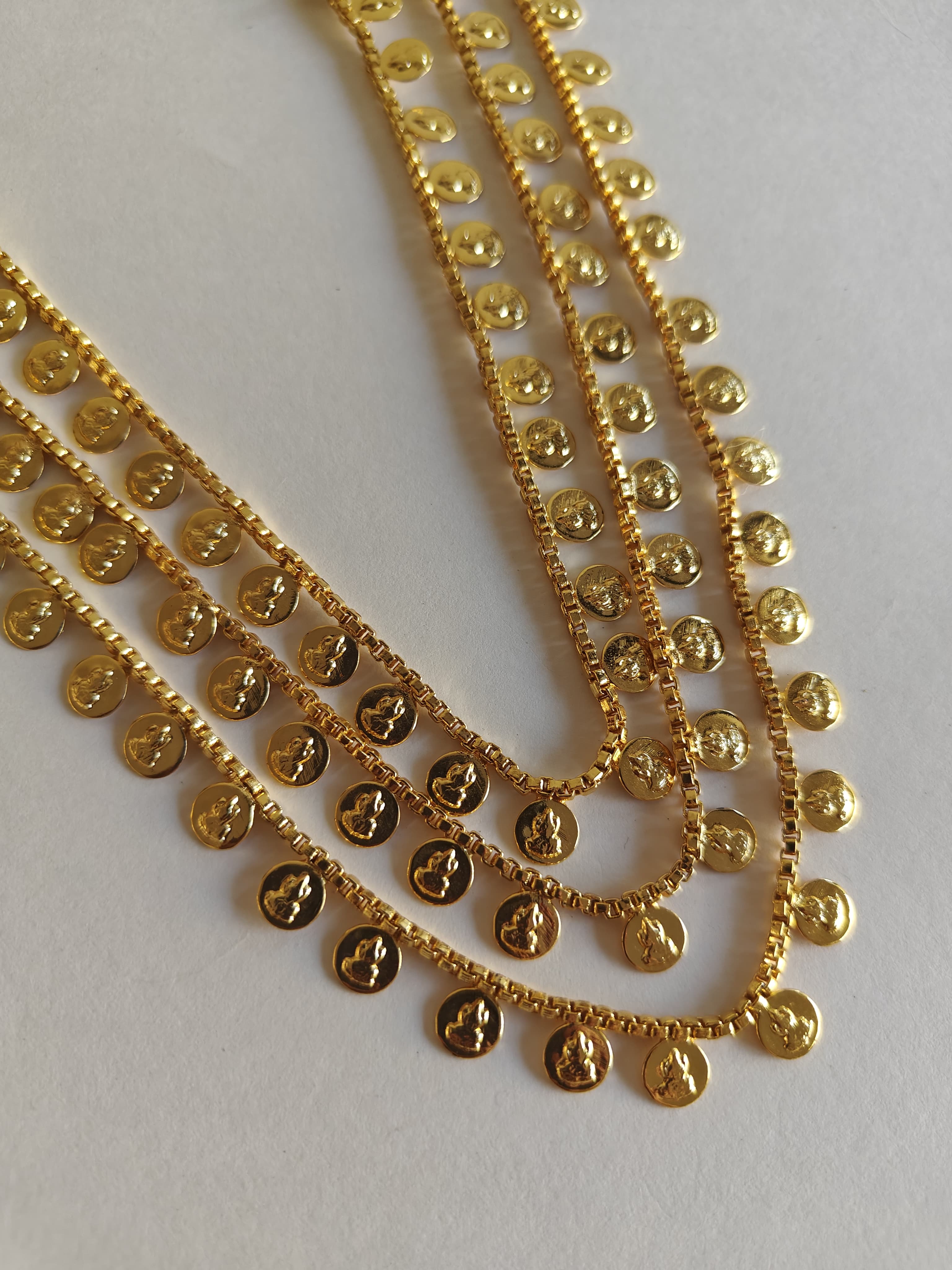 Three layered Lakshmi haar for girls.Effortlessly adjust the length of this three layered Lakshmi haar for girls with the convenient drawstring feature.