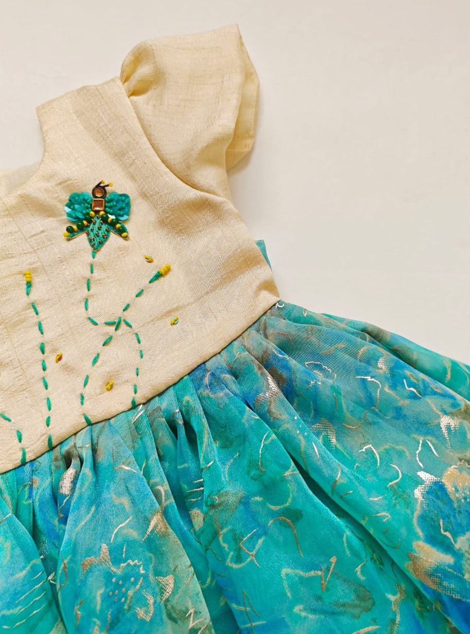 Nyasa silk bodice with foil printed organza bottom dress with handwork, beaded fly motifs for Girl.Let your princess be as comfortable as in her casuals with carefully designed & crafted Comfort Ethnic Wear by Soyara Ethnics.Keep her fashion quotient high with timeless patterns, vibrant combinations and royal textiles.