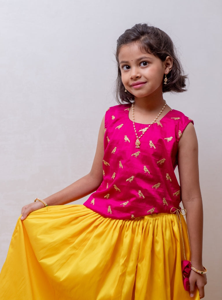 Fresh Yellow soft taffeta silk Ghagra with rani pink asymmetric embroidered gajji silk choli for Girls.Let your princess be as comfortable as in her casuals with carefully designed and crafted Comfort Ethnic Wear by Soyara Ethnics. Keep her fashion quotient high with timeless patterns, vibrant combinations and royal textiles.