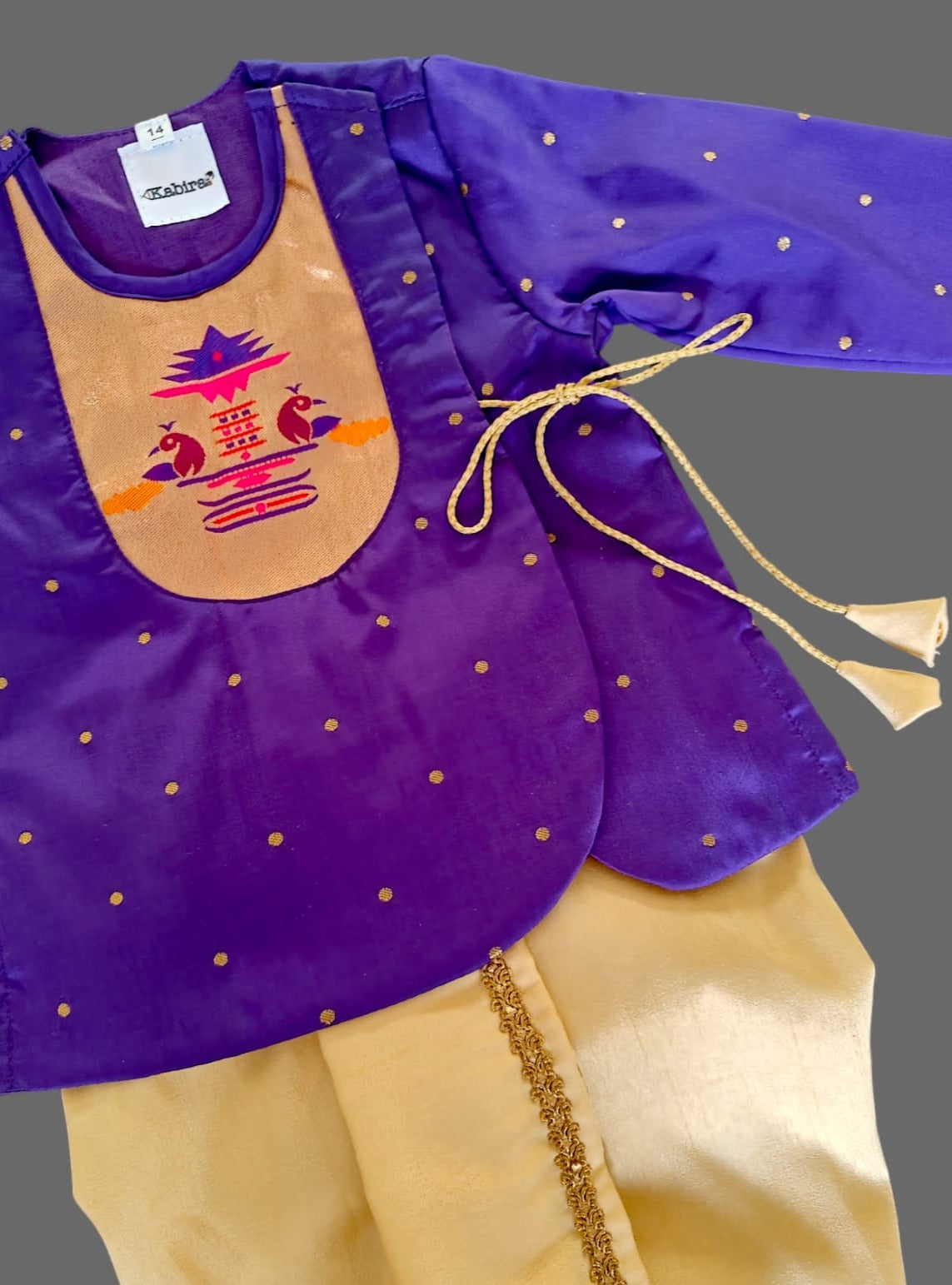 Purple brocade Angrakha kurta with Peacock Paithani yoke teamed with contrast golden dhoti for newborn baby boy.It's the perfect outfit for your baby's naming ceremony,naamkaran,annaprashan ceremony.Traditional dress for Noolukettu Ceremony,Pachavi Puja,cradle ceremony,Rice Ceremony,Chatti Puja etc. Apt gifting idea