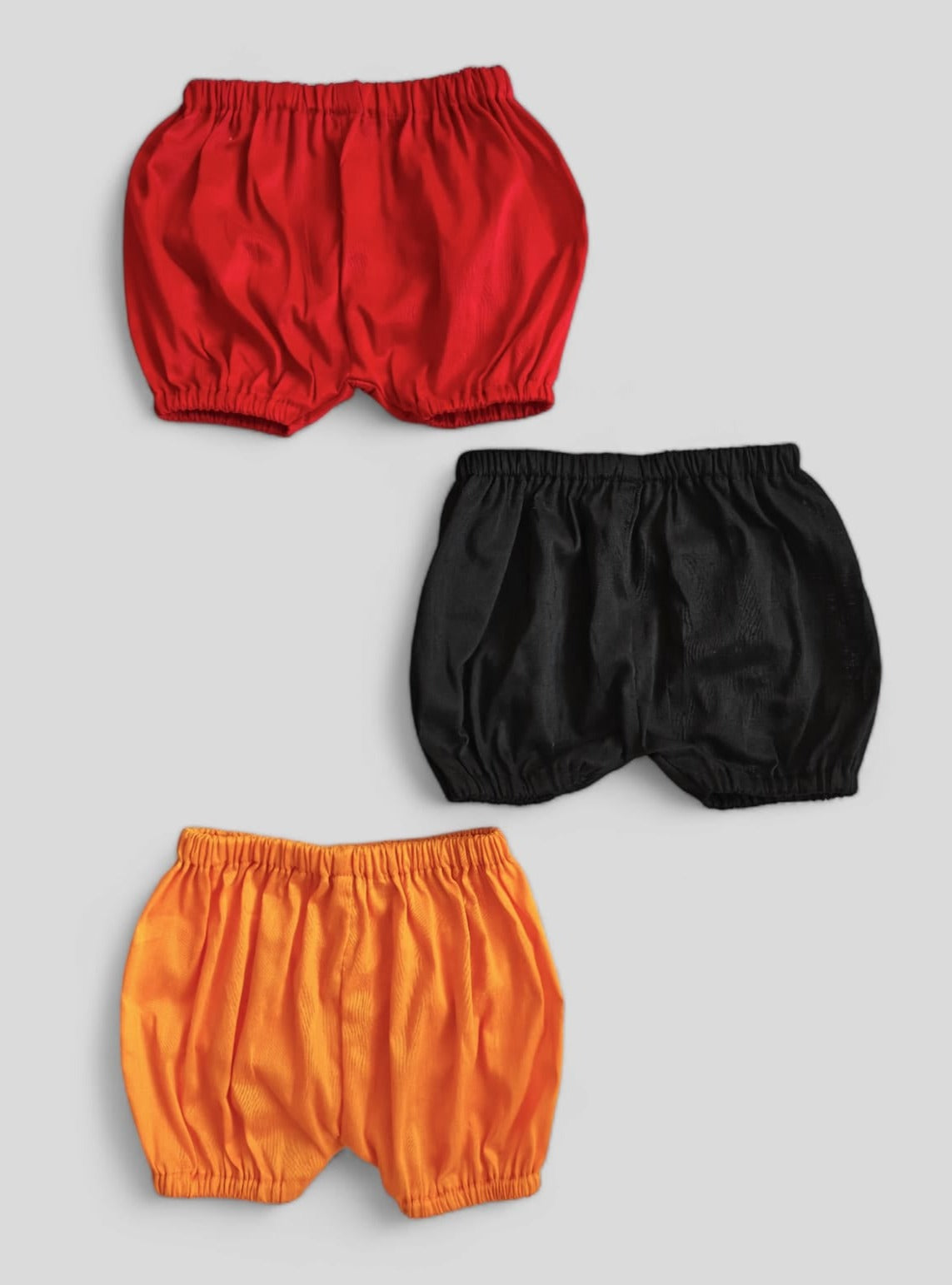 Set of 3 common coloured Baby Bloomers to use over a diaper for Newborn.Golden brocade bonnet,paithani booties,fabric headbands all these Handcrafted accessories for Newborn are perfect add ons to any traditional attire of the baby. Designer baby mats, set of generic bloomers are the other naming ceremony essentials.