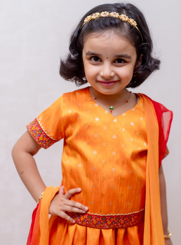 Turmeric Yellow Raw silk Ghagra choli with burning red fulkari embroidered border at the bottom and sleeves for Girls.Let your princess be as comfortable as in her casuals with carefully designed and crafted Comfort Ethnic Wear by Soyara Ethnics. Keep her fashion quotient high with timeless patterns, vibrant combinations and royal textiles.