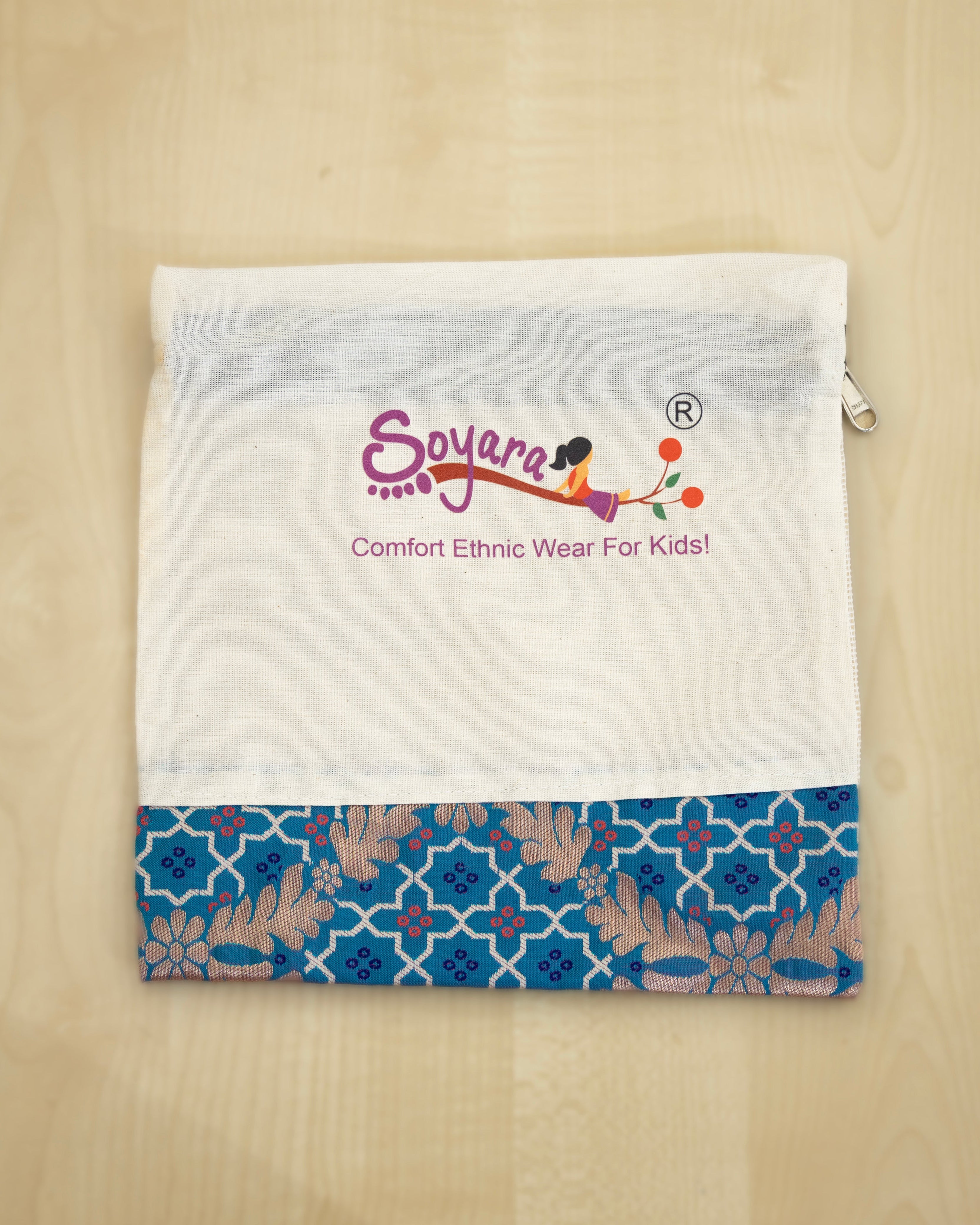 White muslin zipper pouch with blue brocade patch at the bottomfeaturing the 'Soyara' brand logo. Perfect for gift wrapping small garments.