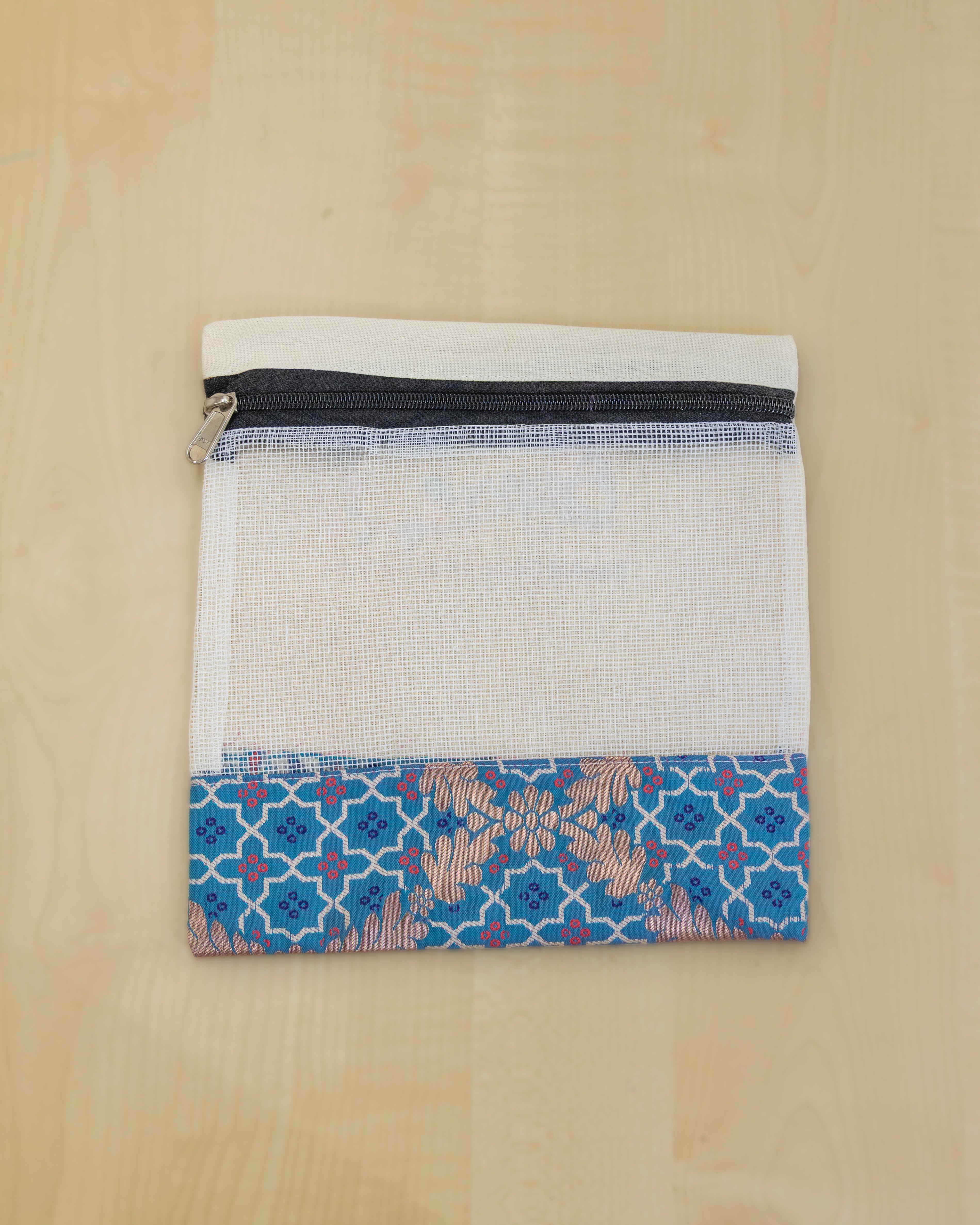 Mesh and muslin pouch pouch with brocade patch at the bottom.