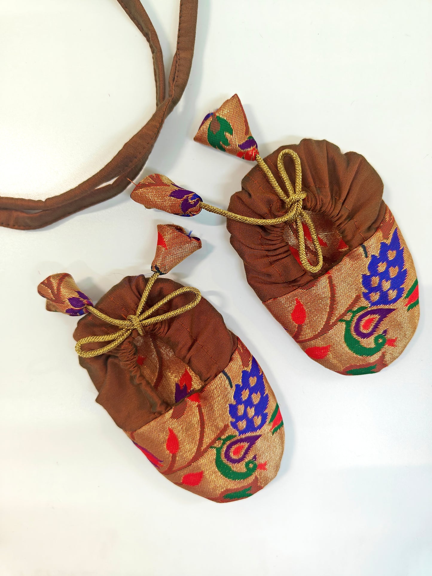 Premium quality Paithani brocade Naming Ceremony Essentials Combo for Baby Boy.Golden brocade bonnet,paithani booties,fabric headbands all these Handcrafted accessories for Newborn are perfect add ons to any traditional attire of the baby.Designer baby mats,set of generic bloomers are other naming ceremony essentials.
