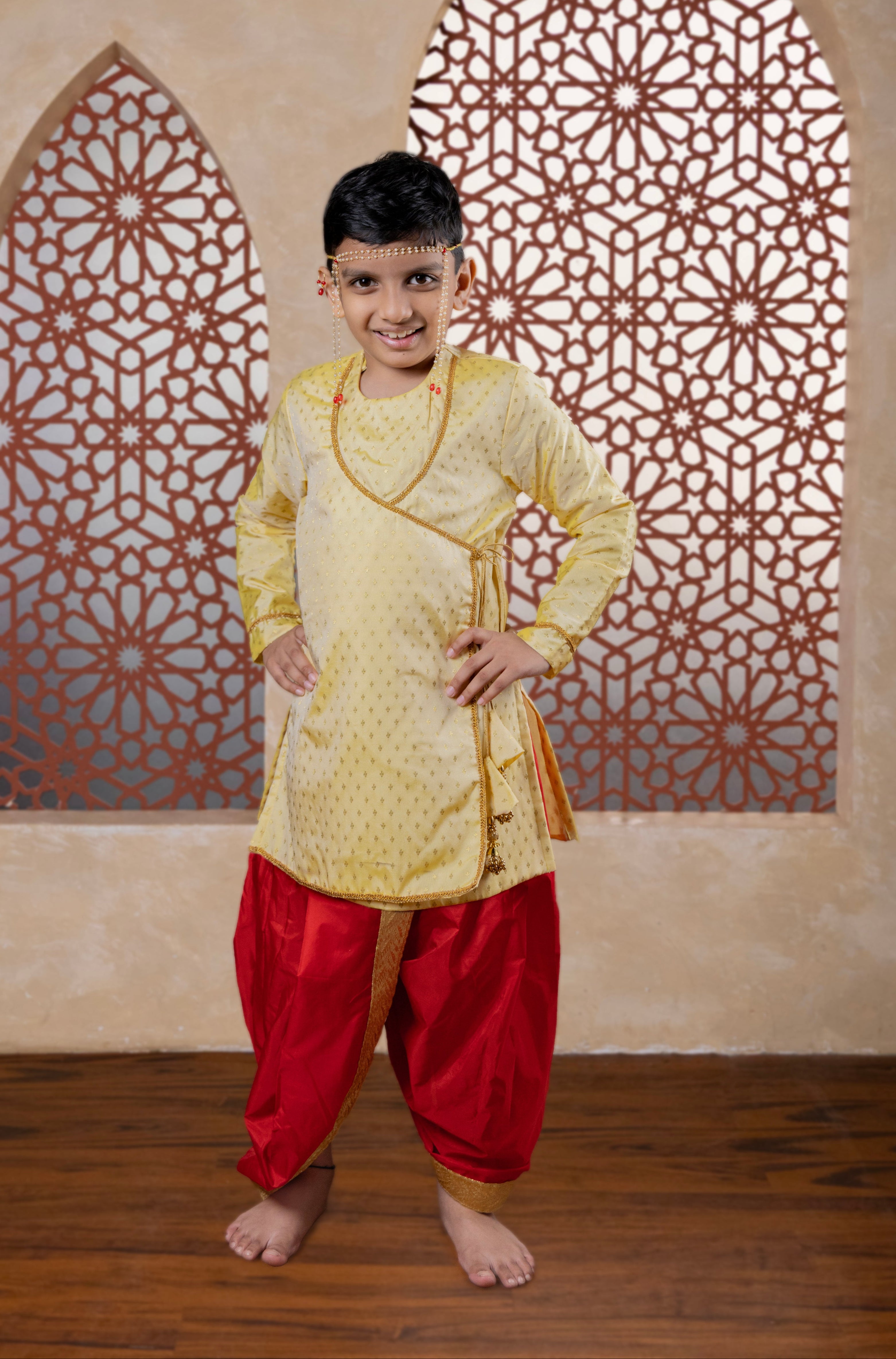 This cream-colored brocade silk kurta features a soft texture and an elegant angarakha design. The intricate neckline detailing combined with handcrafted latkans enhances its regal appeal, making it an ideal choice for a sophisticated, royal-inspired look.