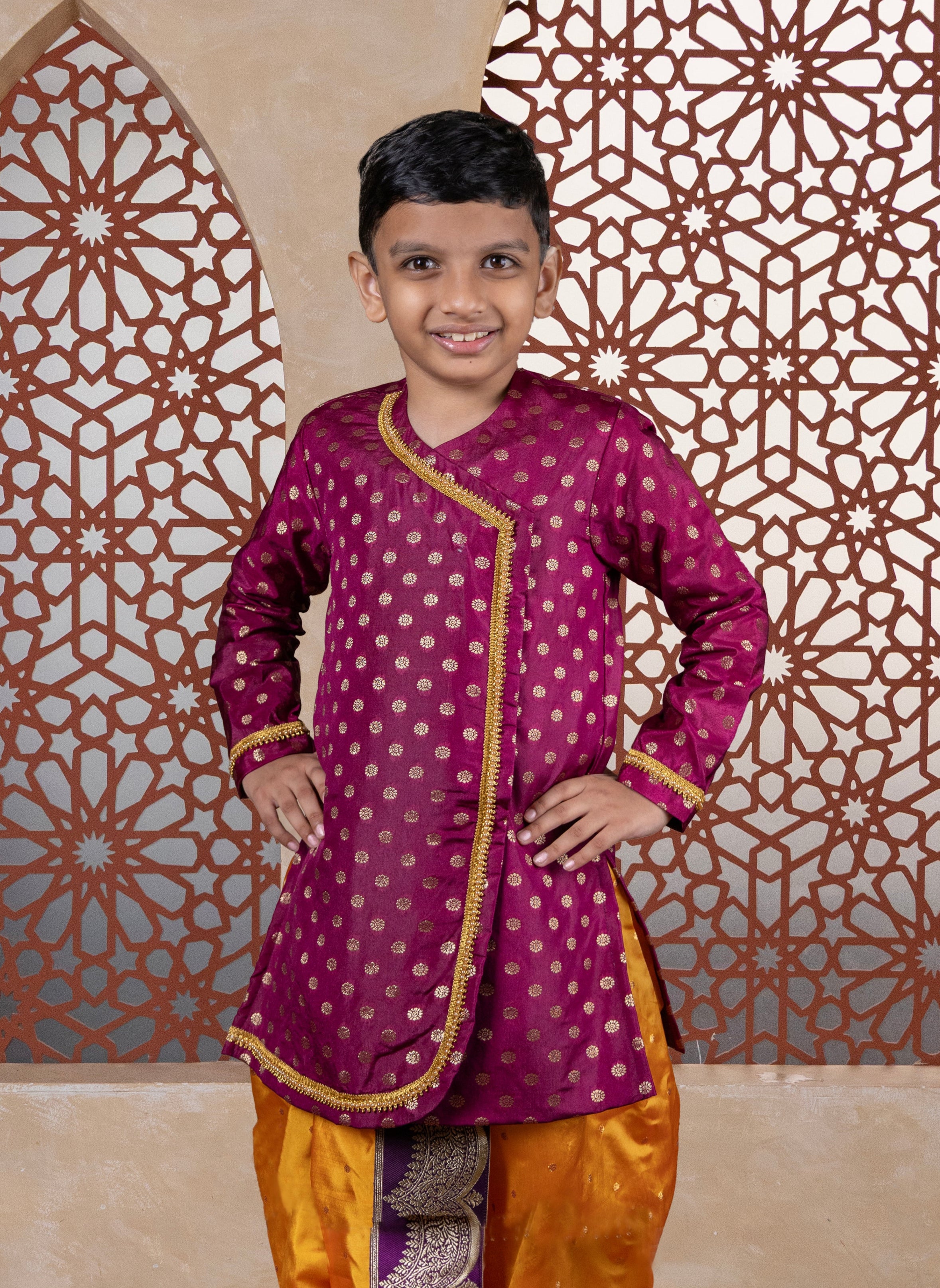 This wine-colored short kurta, crafted from cotton silk, features large jari butta designs and a front open style. Pearls-embellished lace accents delicately outline the curves and cuffs, making it a refined choice for Batu occasions.