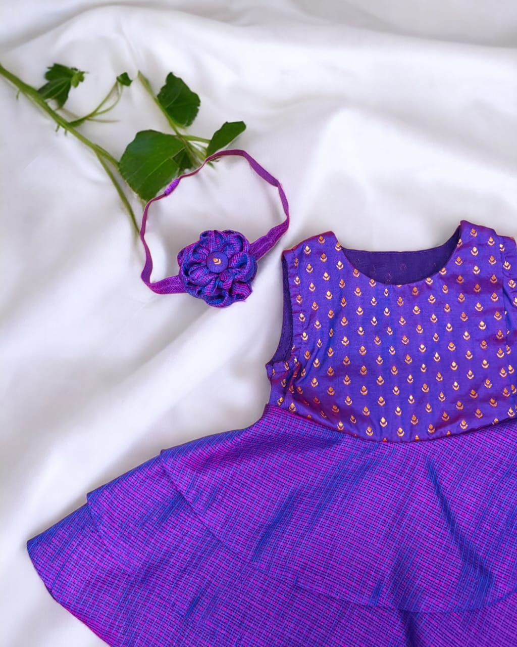 Purple front open layered dress with coordinated bloomer , headband and booties for a newborn baby girl.
