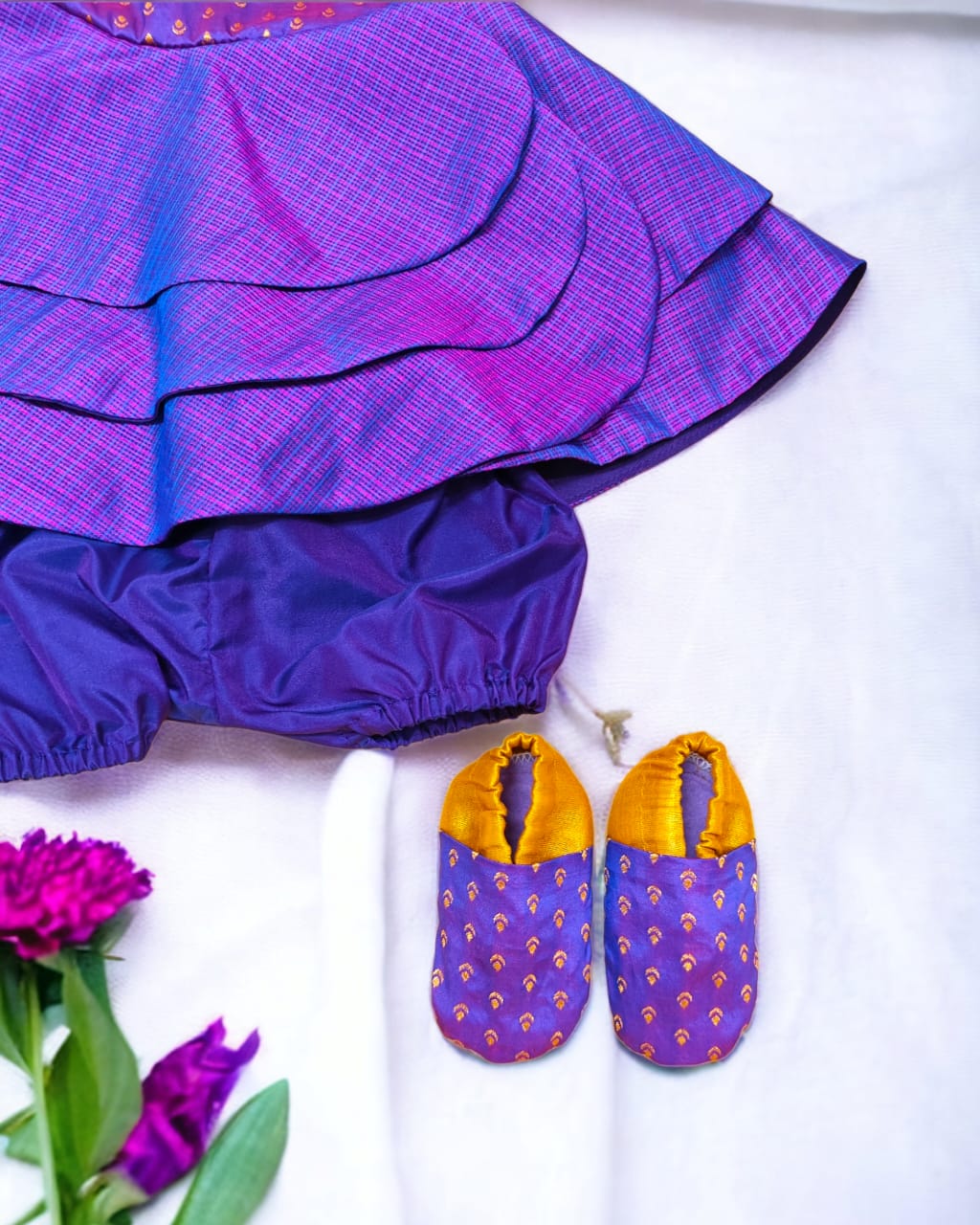 Purple front open layered dress with coordinated bloomer , headband and booties for a newborn baby girl.