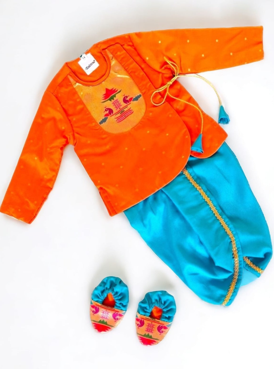 Orange brocade Angrakha kurta with Peacock Paithani yoke teamed with contrast teal blue dhoti for newborn baby boy.It's the perfect outfit for your baby's naming ceremony,naamkaran,annaprashan ceremony.Traditional dress for Noolukettu Ceremony,Pachavi Puja,cradle ceremony,Rice Ceremony,Chatti Puja etc. Apt gifting idea