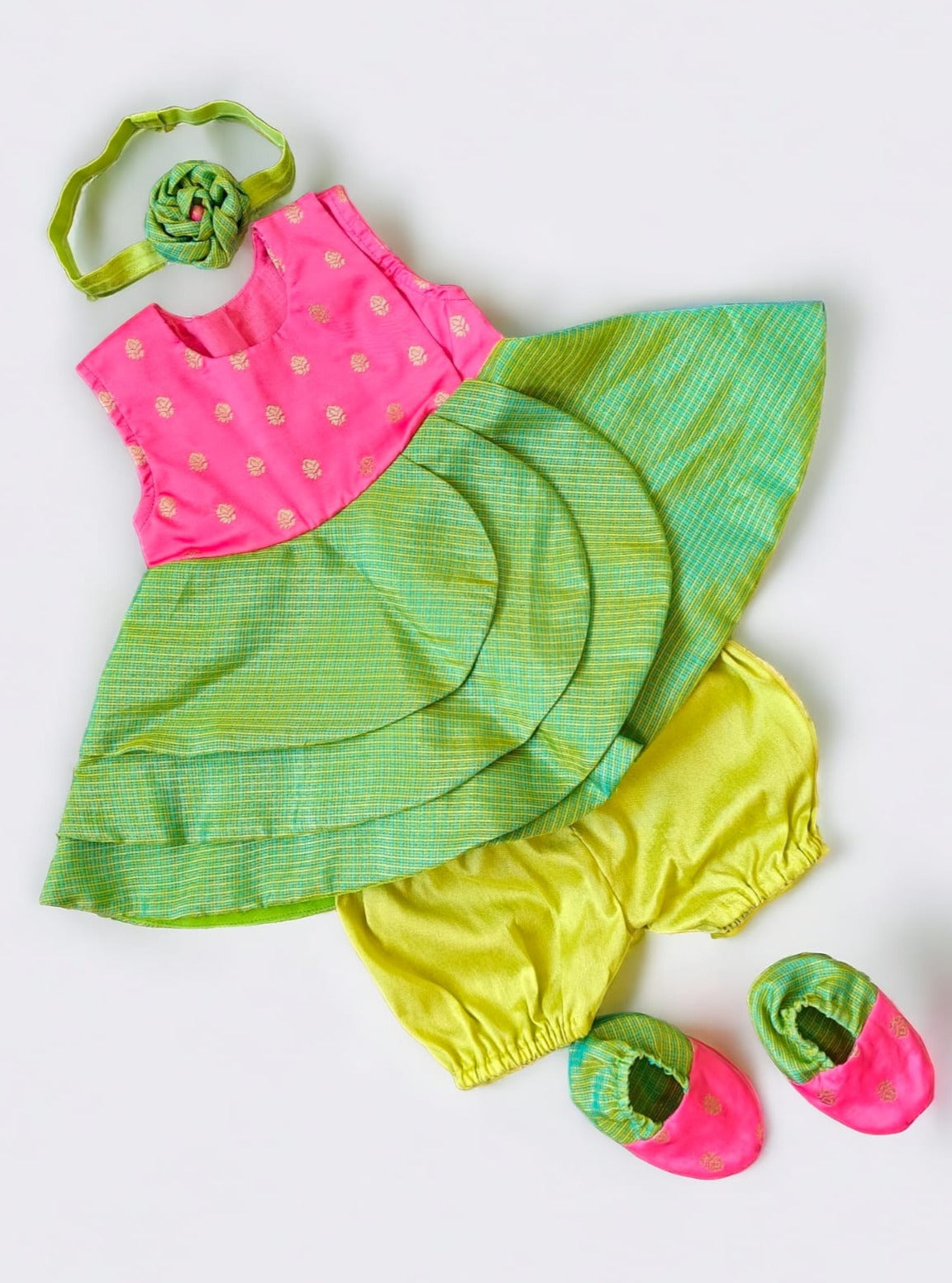 Pink soft brocade & green front open layered dress with bloomer,headband,booties for a newborn baby girl.It's the perfect outfit for your baby's naming ceremony,naamkaran or annaprashan ceremony.Traditional dress for Noolukettu Ceremony,Pachavi Puja,cradle ceremony,Rice Ceremony,Chatti Puja etc. Apt gifting idea