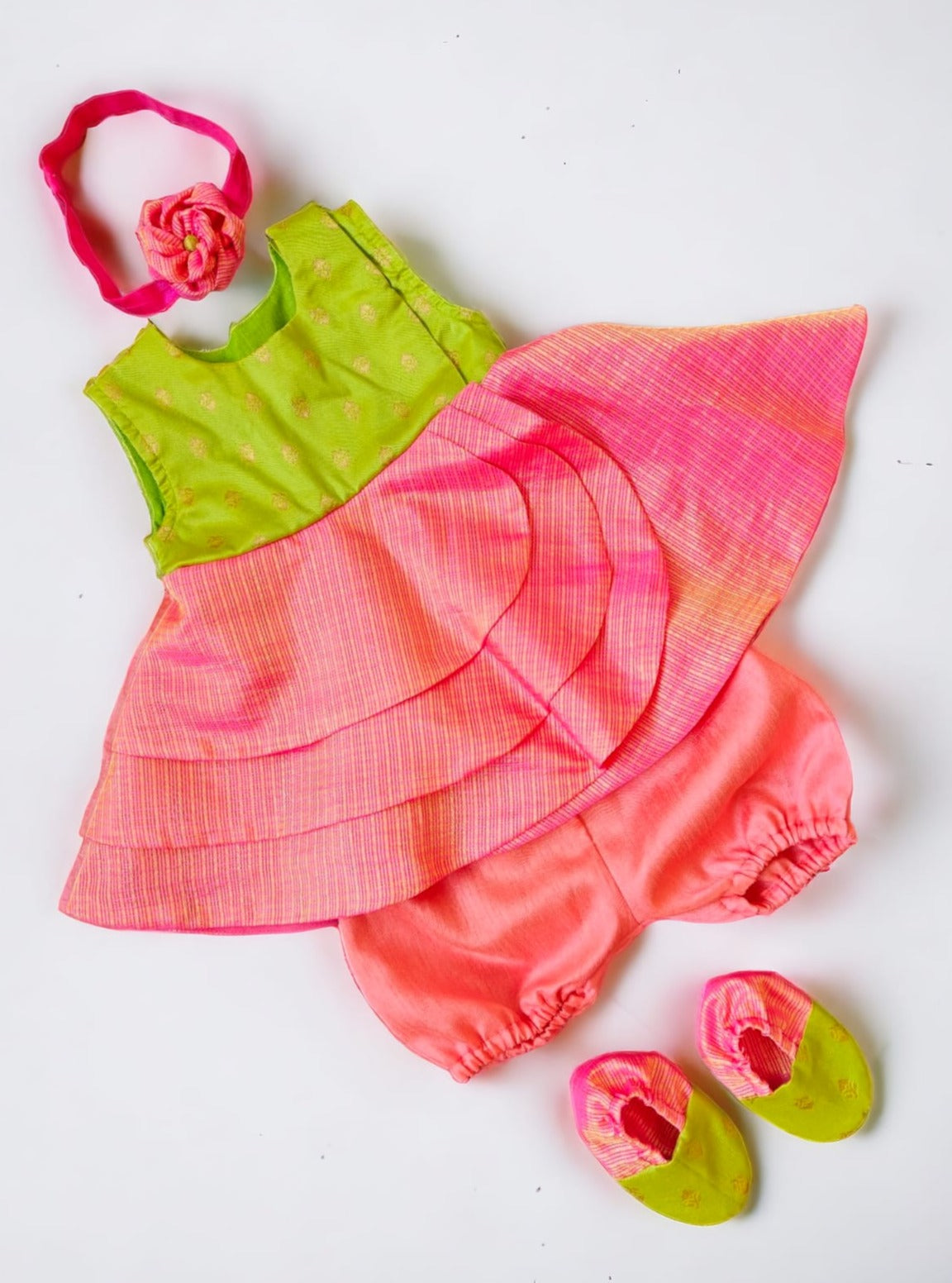 Lime Green soft brocade & pink front open layered dress with bloomer,headband,booties for a newborn baby girl.It's the perfect outfit for your baby's naming ceremony,naamkaran or annaprashan ceremony.Traditional dress for Noolukettu Ceremony,Pachavi Puja,cradle ceremony,Rice Ceremony,Chatti Puja etc. Apt gifting idea