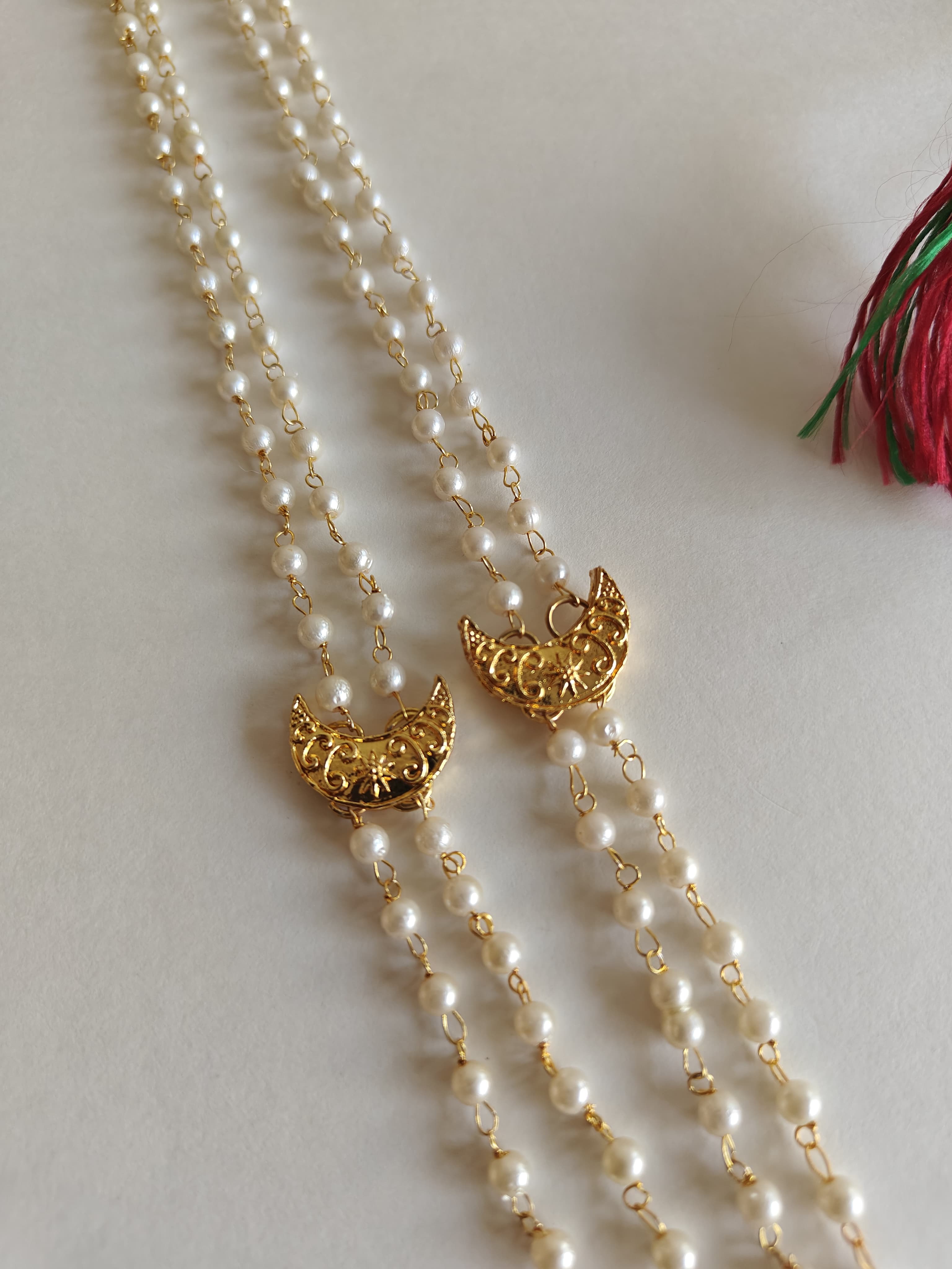 Statement small Chandrakor Kanthi for Batu.
Round shaped pearls chain neckpiece for boys with unique moon crescent findings give final touch to the Royal Look!