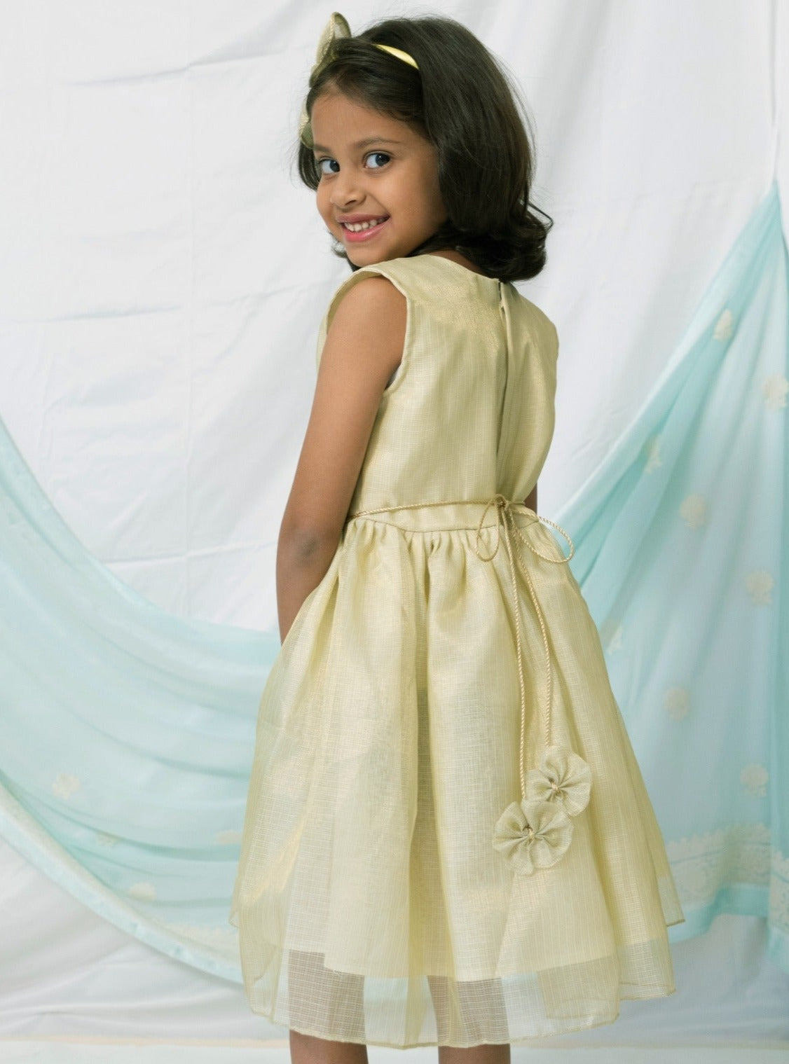 Citrus Green tissue kotta silk sleeveless flared dress with statement embellished bow for Girl.Let your princess be as comfortable as in her casuals with carefully designed and crafted Comfort Ethnic Wear by Soyara Ethnics. Keep her fashion quotient high with timeless patterns, vibrant combinations and royal textiles.