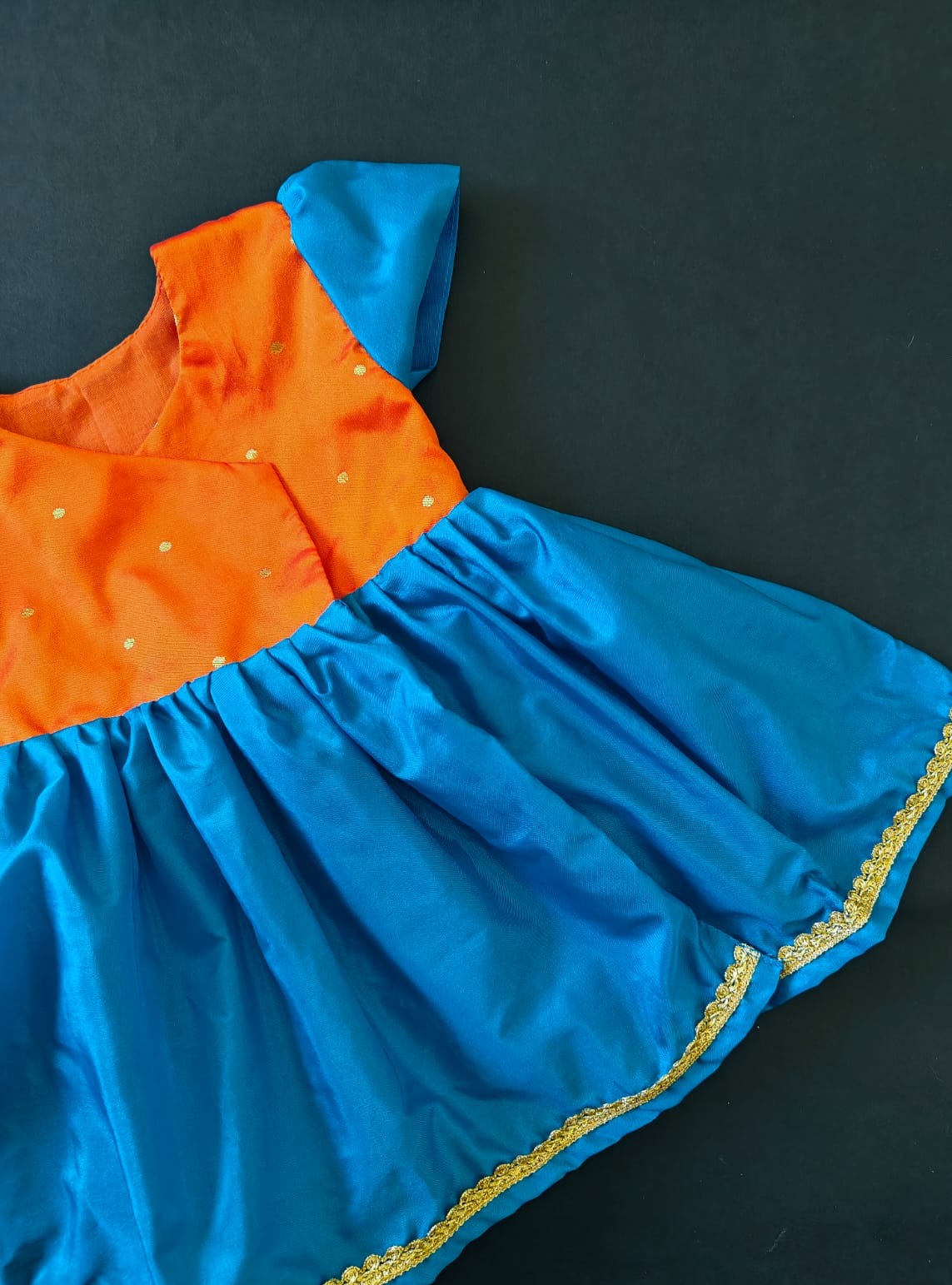 Orange brocade & teal blue silk front open dress for new born Baby Girl provides max comfort. It's the perfect outfit for your baby's naming ceremony , naamkaran or annaprashan ceremony. Traditional and ethnic dress for Noolukettu Ceremony, Paachvi Puja, Cradle ceremony,Rice Ceremony,Chatti Puja etc. Apt gifting idea.