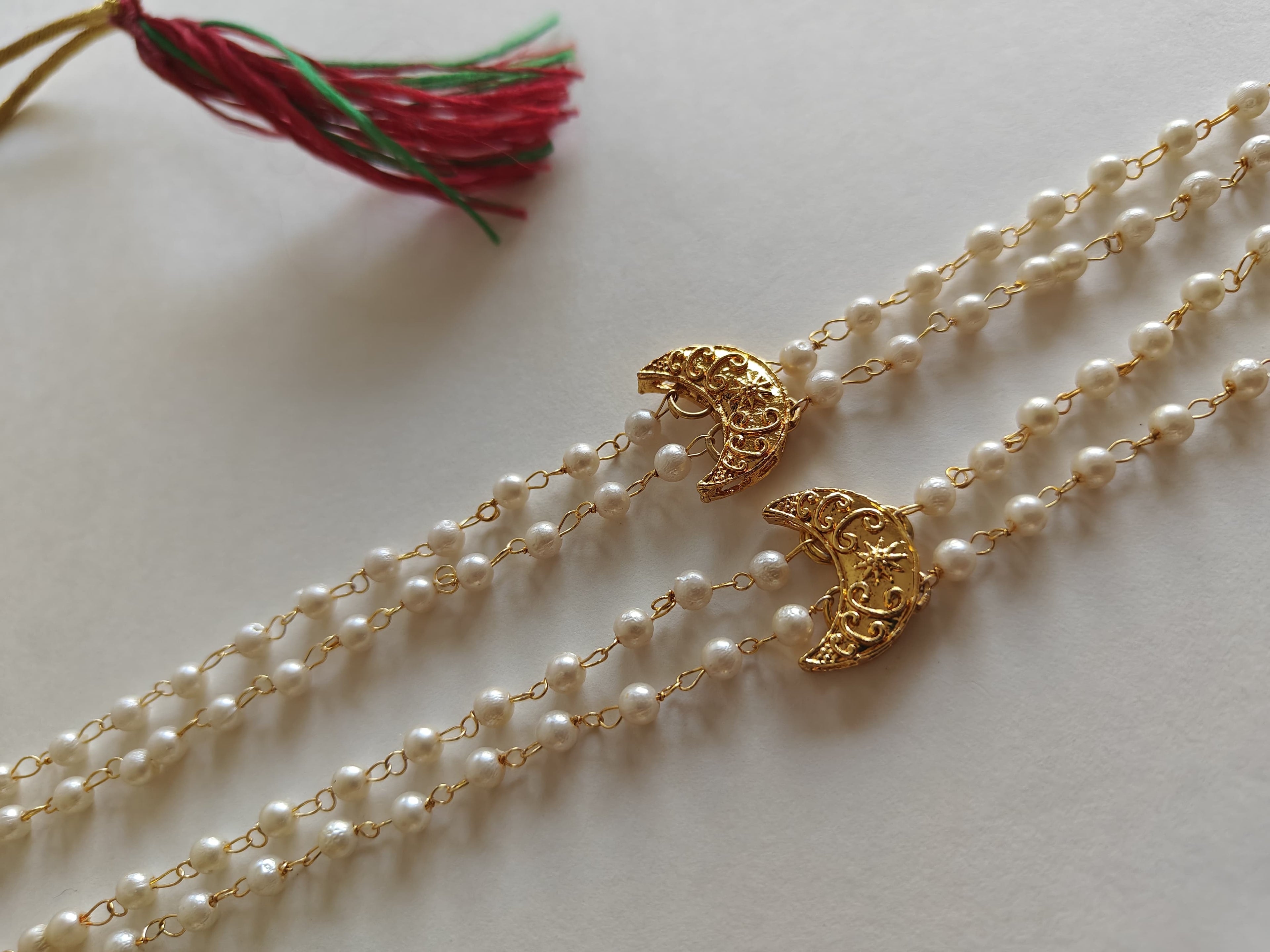 Statement small Chandrakor Kanthi for Batu.
Round shaped pearls chain neckpiece for boys with unique moon crescent findings give final touch to the Royal Look!