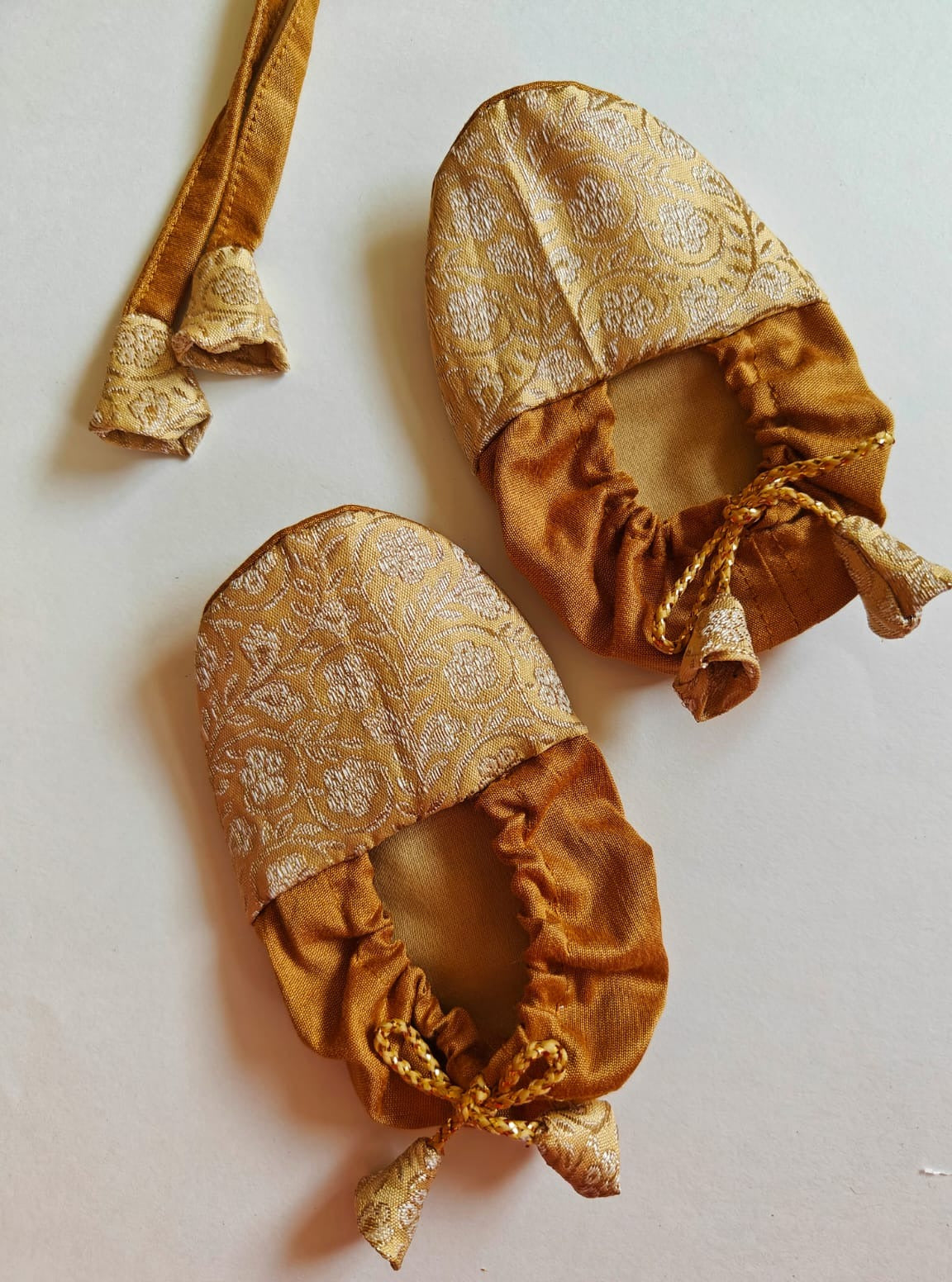 Golden Paithani Naming Ceremony Combo for Baby Boy includes Bonnet,Booties.Golden brocade bonnet,paithani booties,fabric headbands all these Handcrafted accessories for Newborn are perfect add ons to any traditional attire of the baby.Designer baby mats,set of generic bloomers are other naming ceremony essentials.