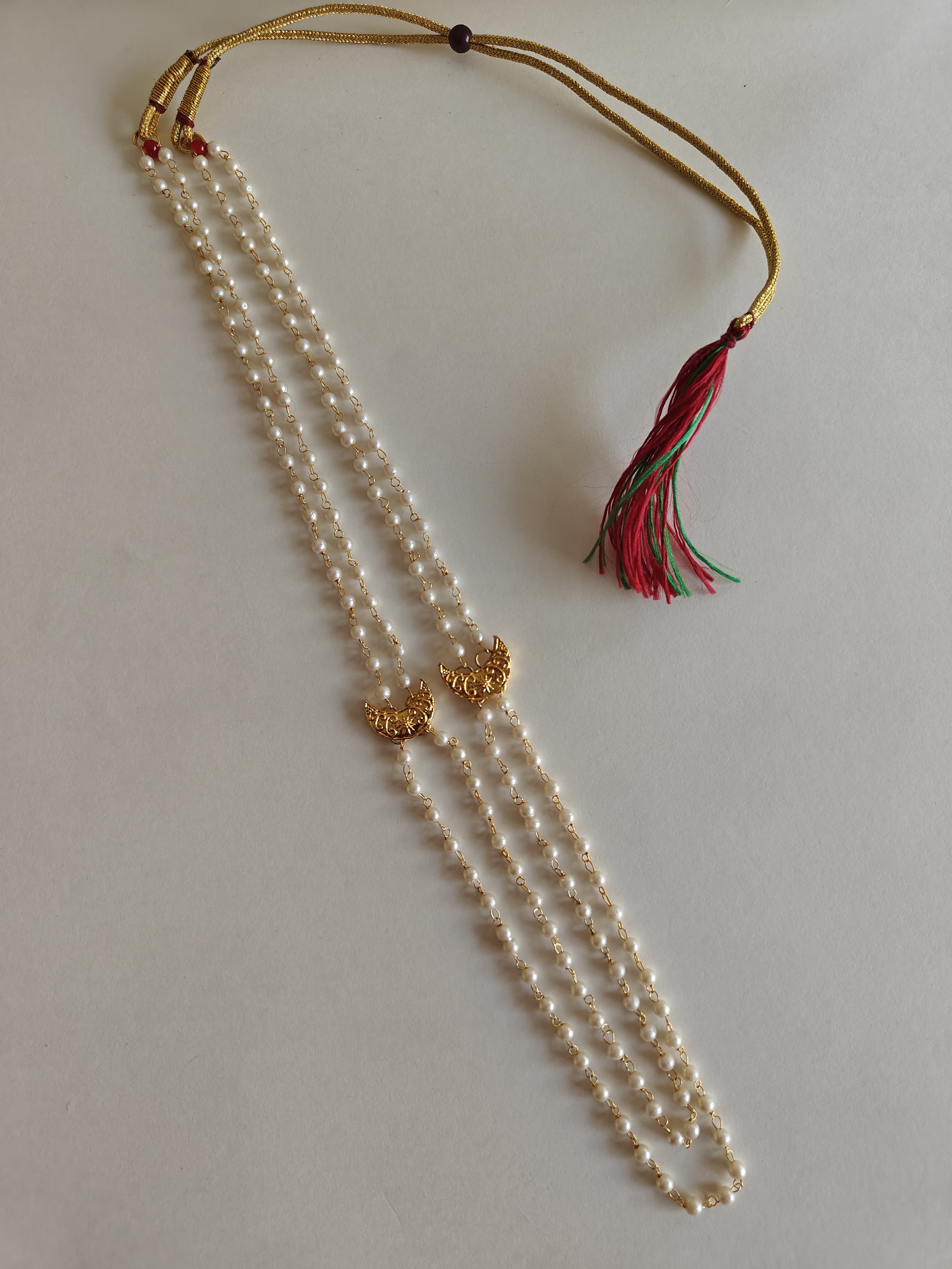 Statement small Chandrakor Kanthi for Batu.
Round shaped pearls chain neckpiece for boys with unique moon crescent findings give final touch to the Royal Look!