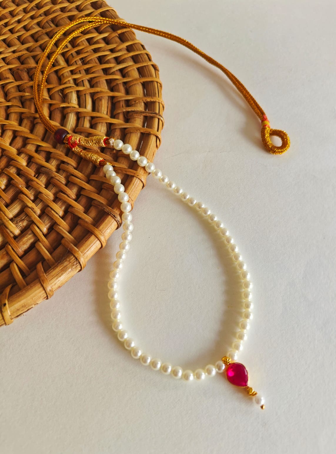 This necklace features semi-cultured pearls and a Karwari Drop shaped Pink Stone Pendant, perfect for girls. The length is 13 inches with an adjustable drawstring for added convenience.