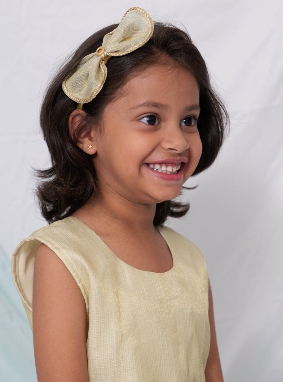 Citrus Green tissue kotta silk sleeveless flared dress with statement embellished bow for Girl.Let your princess be as comfortable as in her casuals with carefully designed and crafted Comfort Ethnic Wear by Soyara Ethnics. Keep her fashion quotient high with timeless patterns, vibrant combinations and royal textiles.