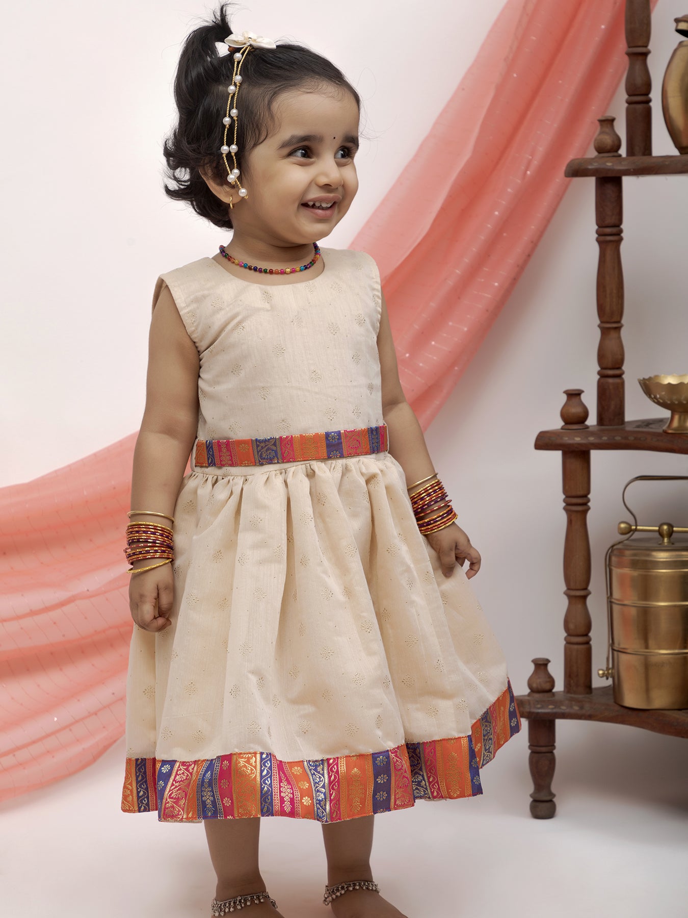 Ivory foil printed Chanderi Frock with banaras silk jacket for Girl.Let your princess be as comfortable as in her casuals with carefully designed & crafted Comfort Ethnic Wear by Soyara Ethnics.Keep her fashion quotient high with timeless patterns, vibrant combinations and royal textiles.